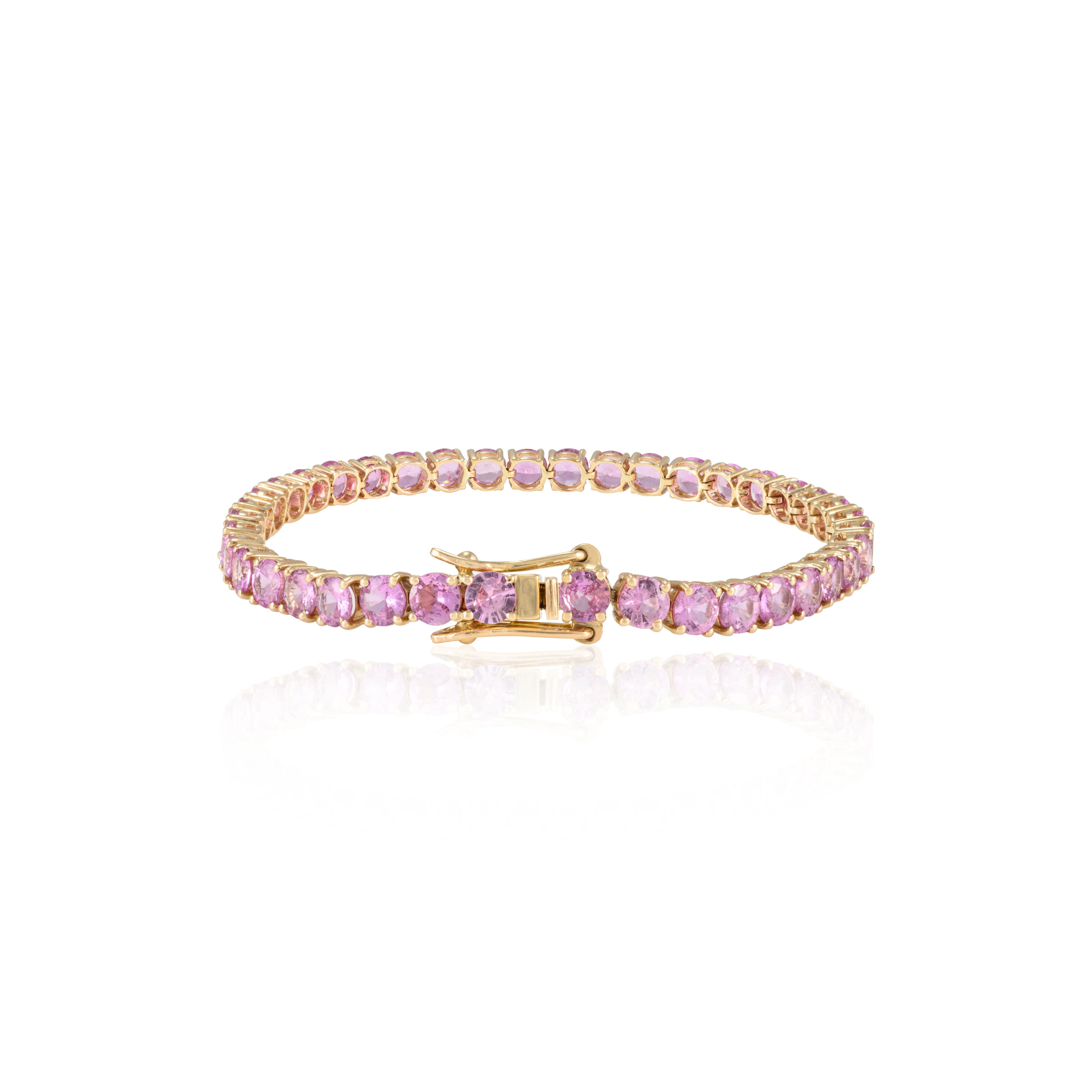 This Brilliant Pink Sapphire Tennis Bracelet in 14K gold showcases 14.83 carat endlessly sparkling natural pink sapphire. It measures 7 inches long in length. 
Sapphire stimulates concentration and reduces stress. 
Designed with perfect round cut