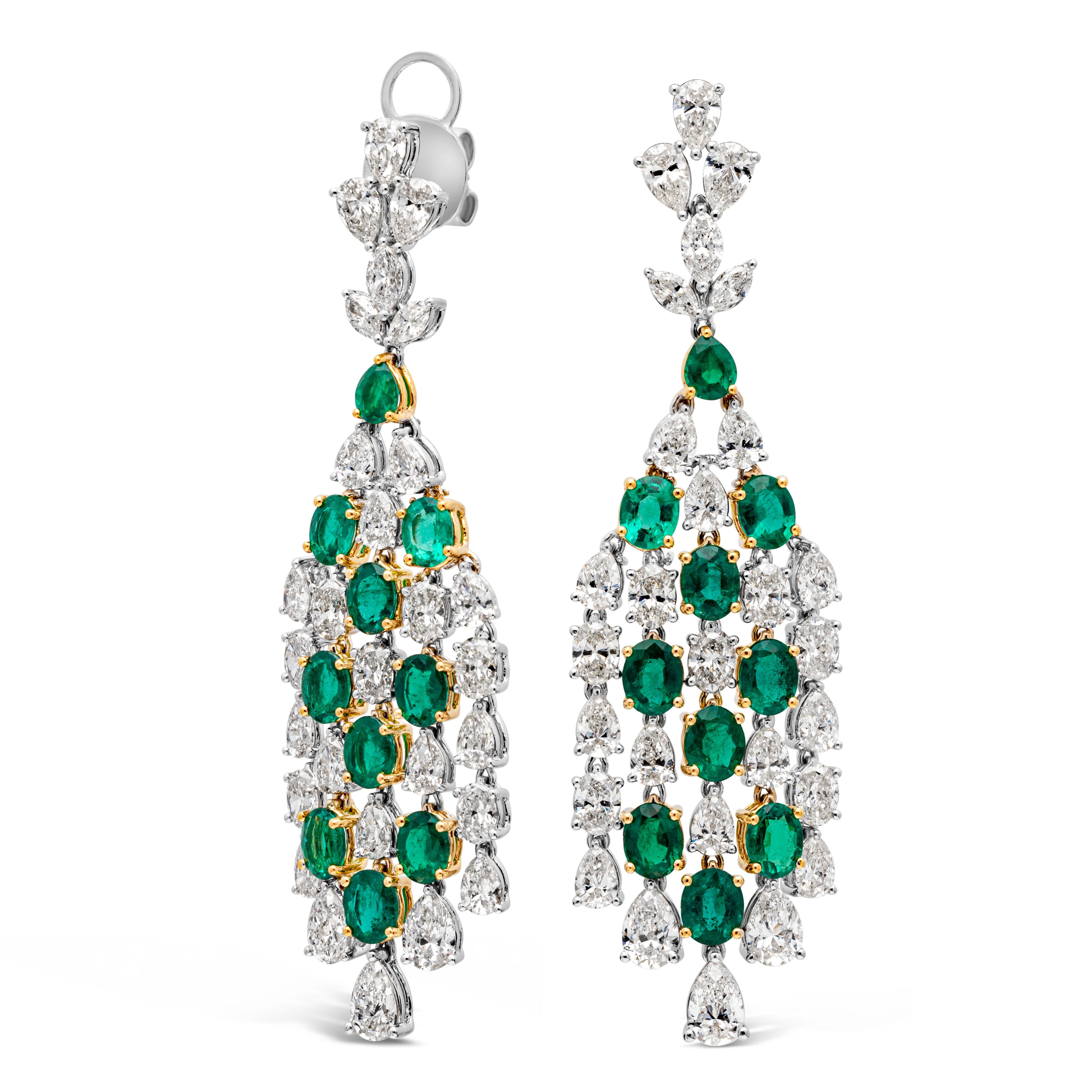 A delicate and exquisite pair of chandelier earrings showcasing 5.92 carats total of 18 oval cut and 1 pear shape color-rich green emerald, set in an elegant dangling waterfall design with 8.92 carats total of brilliant oval, pear and marquise cut