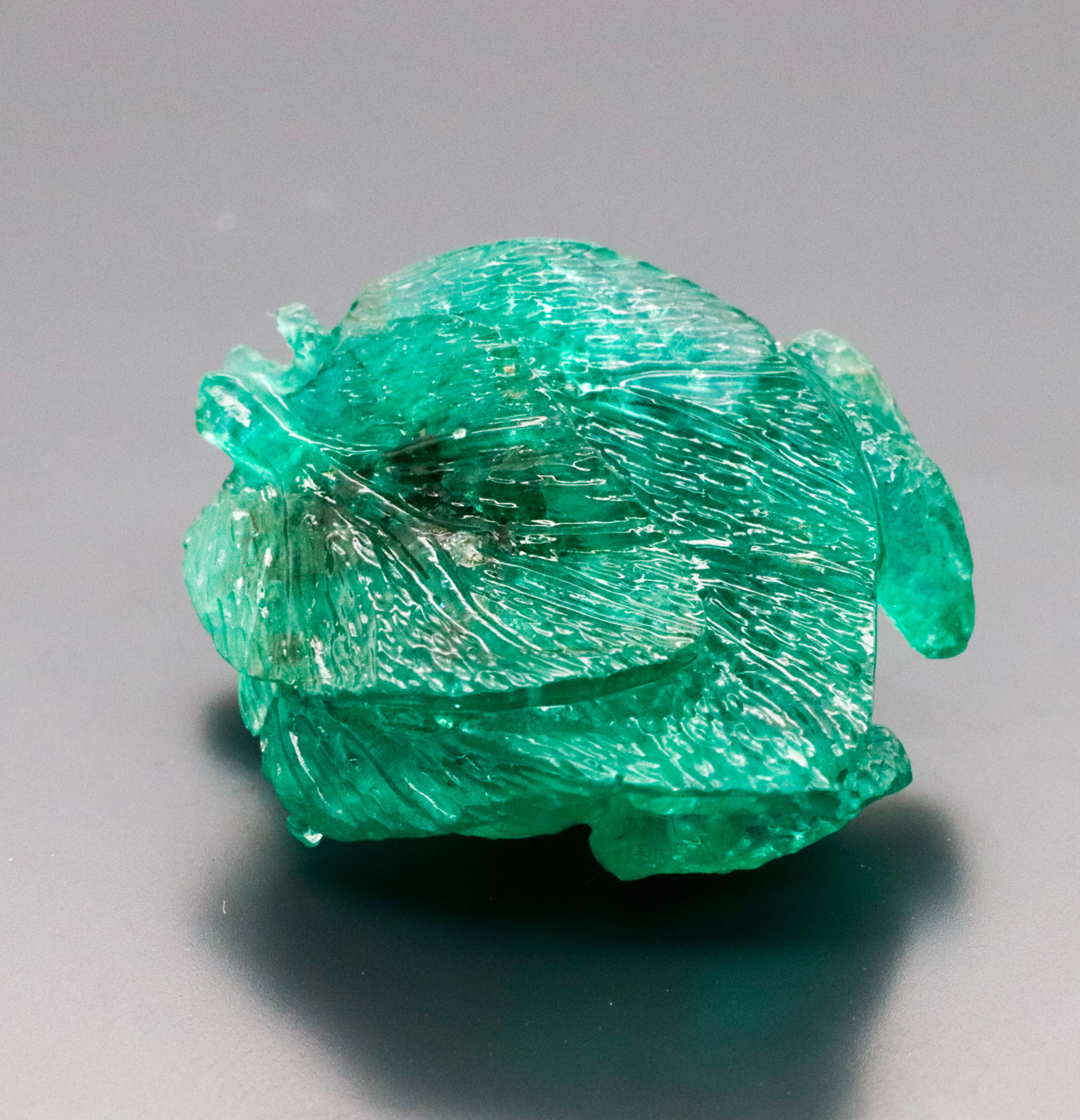 This green Emerald is curved, as if the frog is resting on a leaf. The emerald also features an exceptionally vivid green color.  It is carefully curved and expertly crafted to enhance its natural beauty and show off its lively green hue.

This