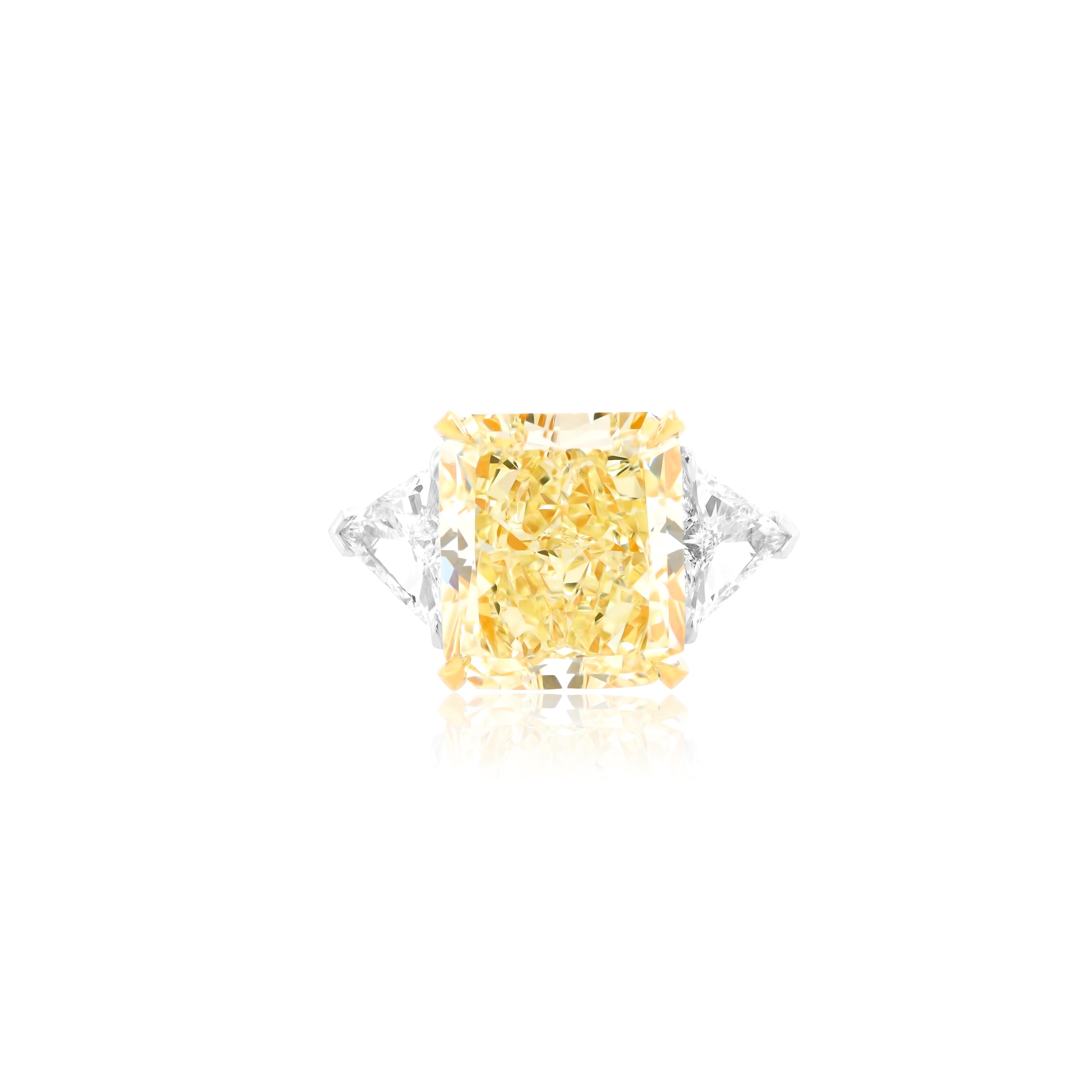 Magnificent Platinum and 18kt Yellow gold fancy yellow diamond engagement ring with center GIA certified 14.89 Carats Fancy Yellow VVS2 radiant cut diamond set with two triangular, features 1.92 carats


