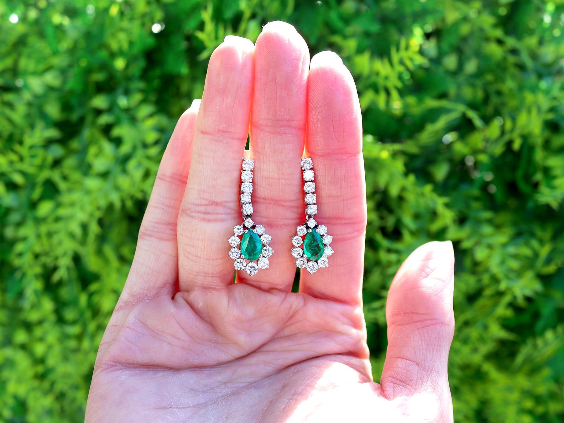 A stunning, fine and impressive pair of vintage 1.48 carat emerald and 2.35 carat diamond, 18 karat white gold drop earrings; part of our diverse collection of vintage emerald jewelry.

These stunning vintage emerald drop earrings have been crafted