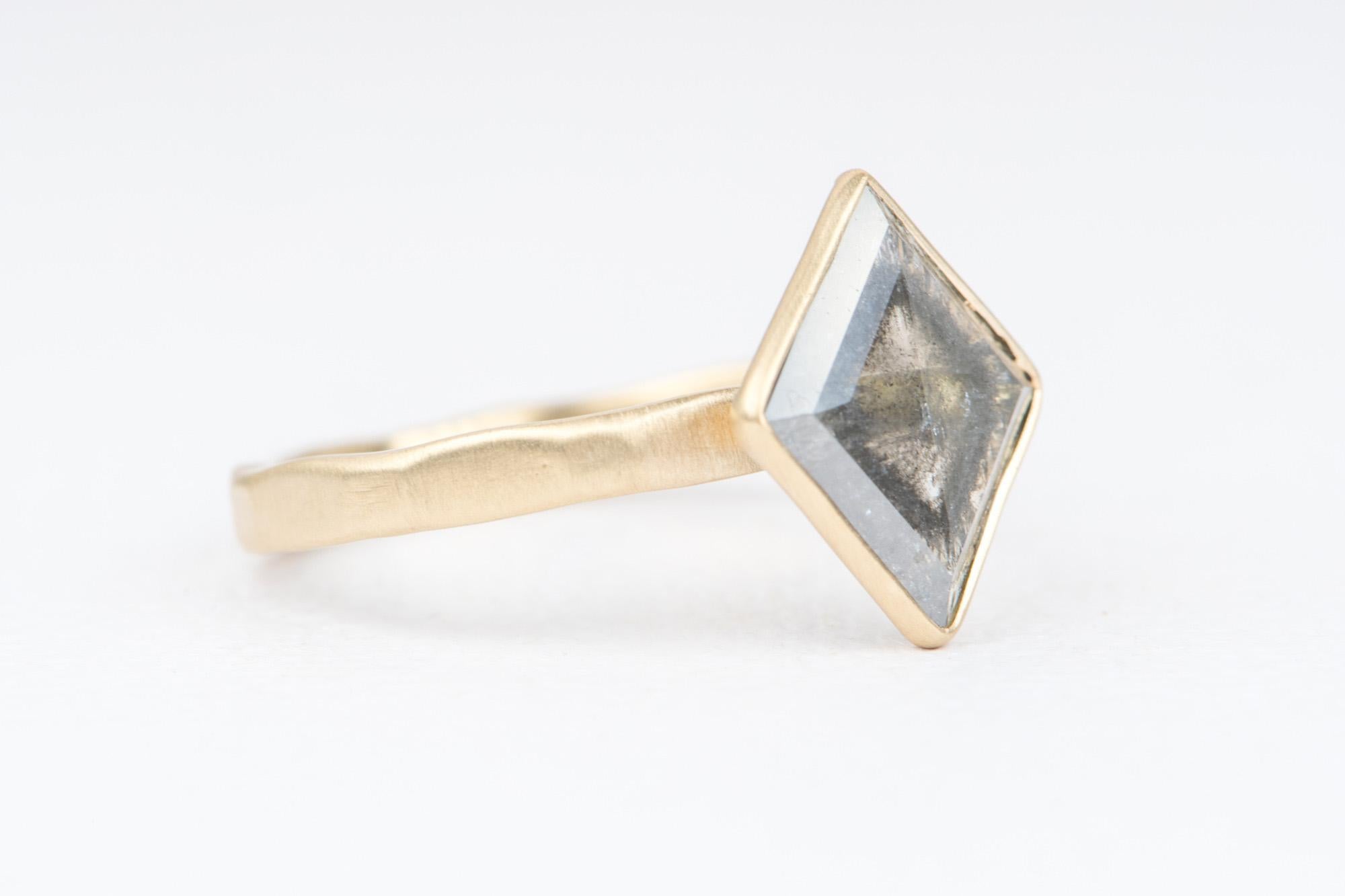 ♥ Solid 14K yellow gold ring set with a beautiful kite-shaped salt and pepper diamond
♥ The diamond is bezel set on a hammered thick shank. The outside of the ring has a matte finish for a subdued look.
♥ The setting measures 13.2*11.6mm including