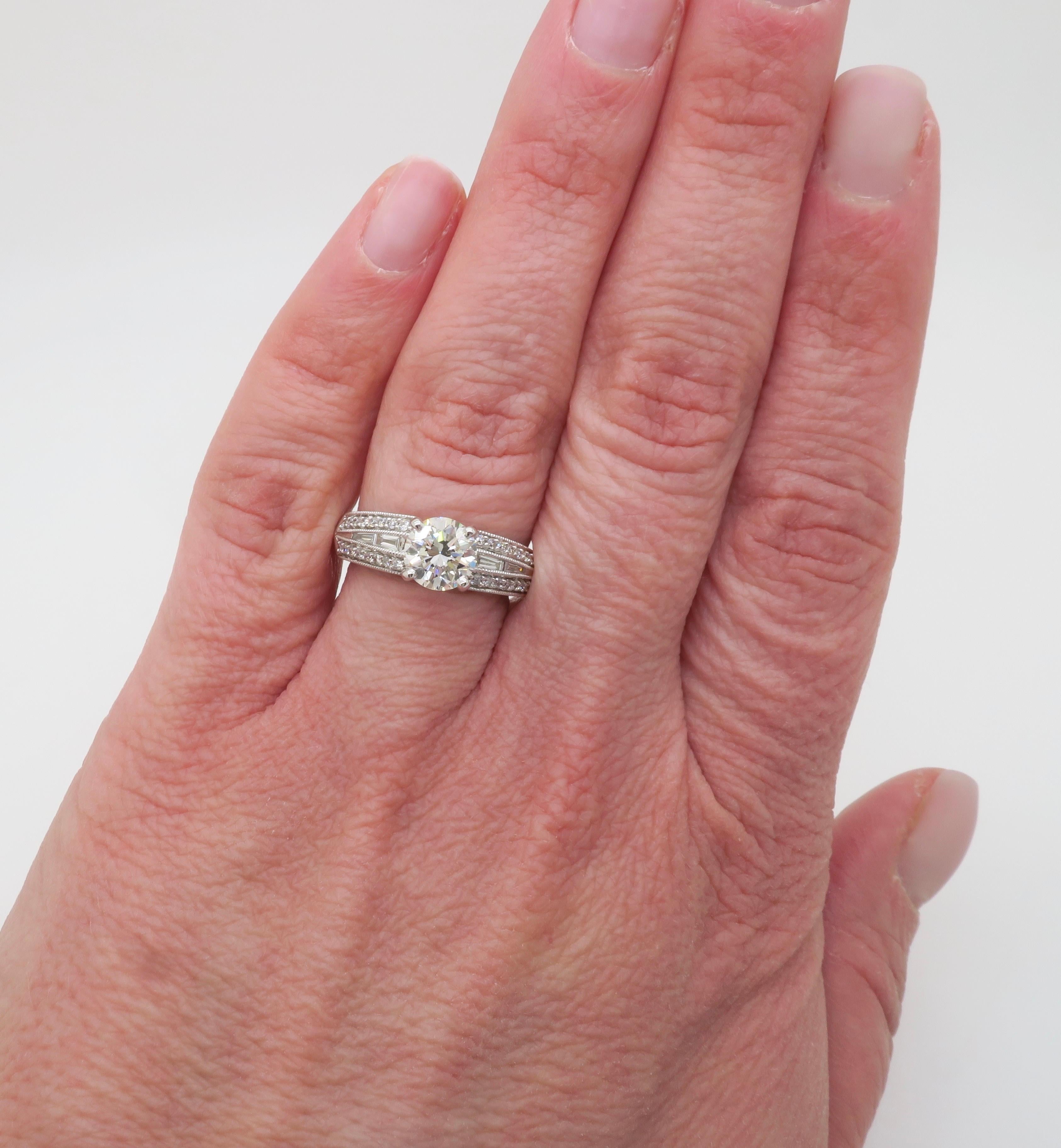 Beautiful GIA certified diamond ring with Baguette & Round Brilliant cut diamonds. 

Center Diamond Carat Weight: 1.08CT
Center Diamond Cut: Round Brilliant  
Center Diamond Color: J
Center Diamond Clarity: SI1
Certification: GIA - 2235439101
Total