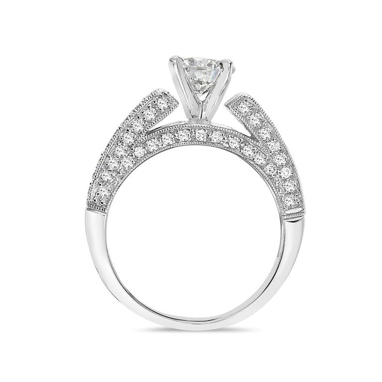 This engagement ring features a 0.99 carat round diamond surrounded by 0.50 carats of pave diamonds set in 18K white gold. 8.8 grams total weight. Size 7 1/4. Made in Italy. 

Resizeable upon request.

Viewings available in our NYC showroom by