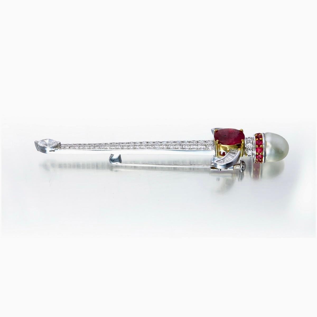 An elegant ruby diamond and pearl brooch made by Rewa jewels in 18 karat white gold.

Features a rare natural Burmese ruby 1.23 carat weight approximately, priced for its vibrant, untreated colour. Along with twelve round shaped rubies weighing