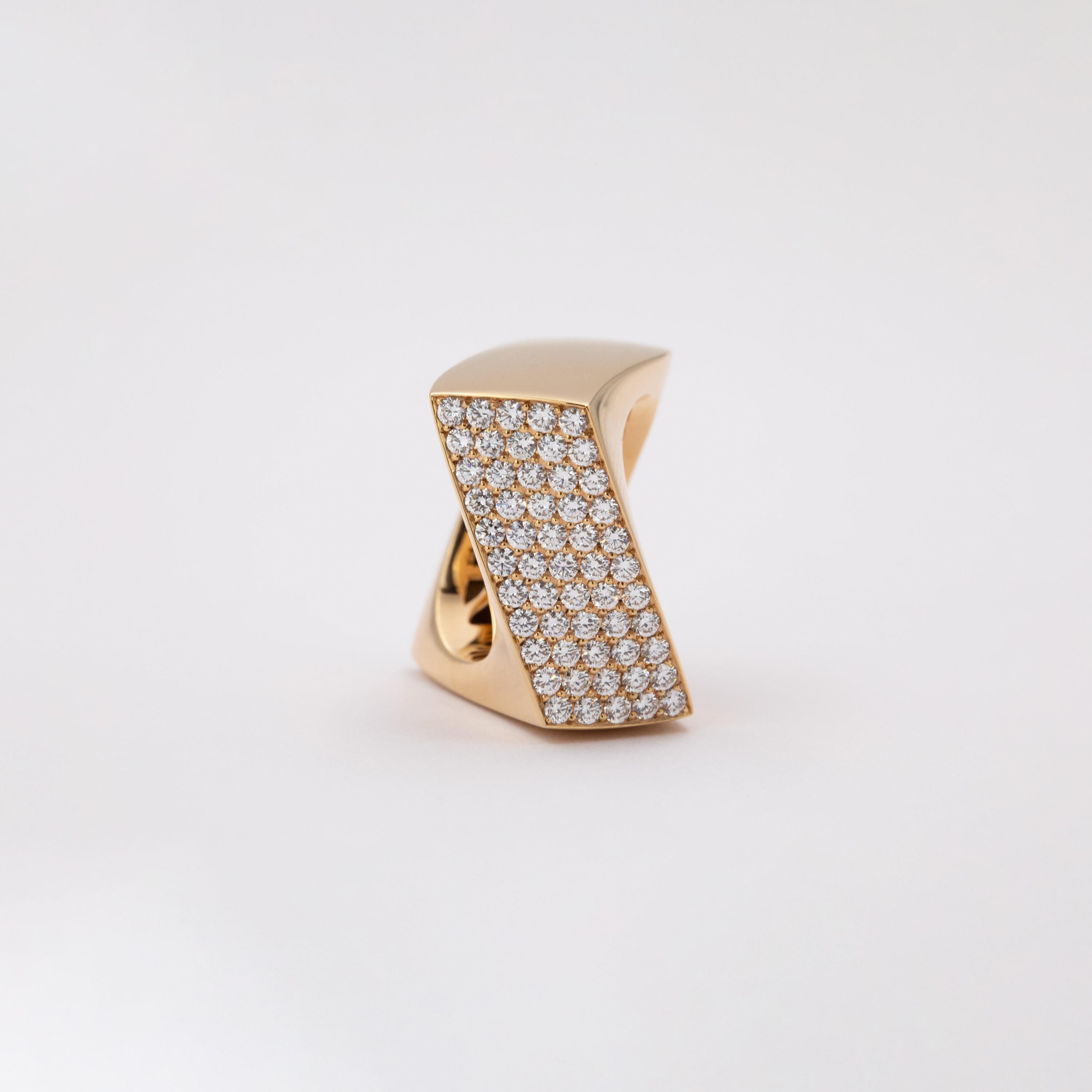 This sophisticated and clean design displays the diamonds in a refreshing new way. The cubic shank form is strongly twisted, resulting in a dynamic shape. With its bent form, the diamond-encrusted surface of the ring luxuriously presents an array of
