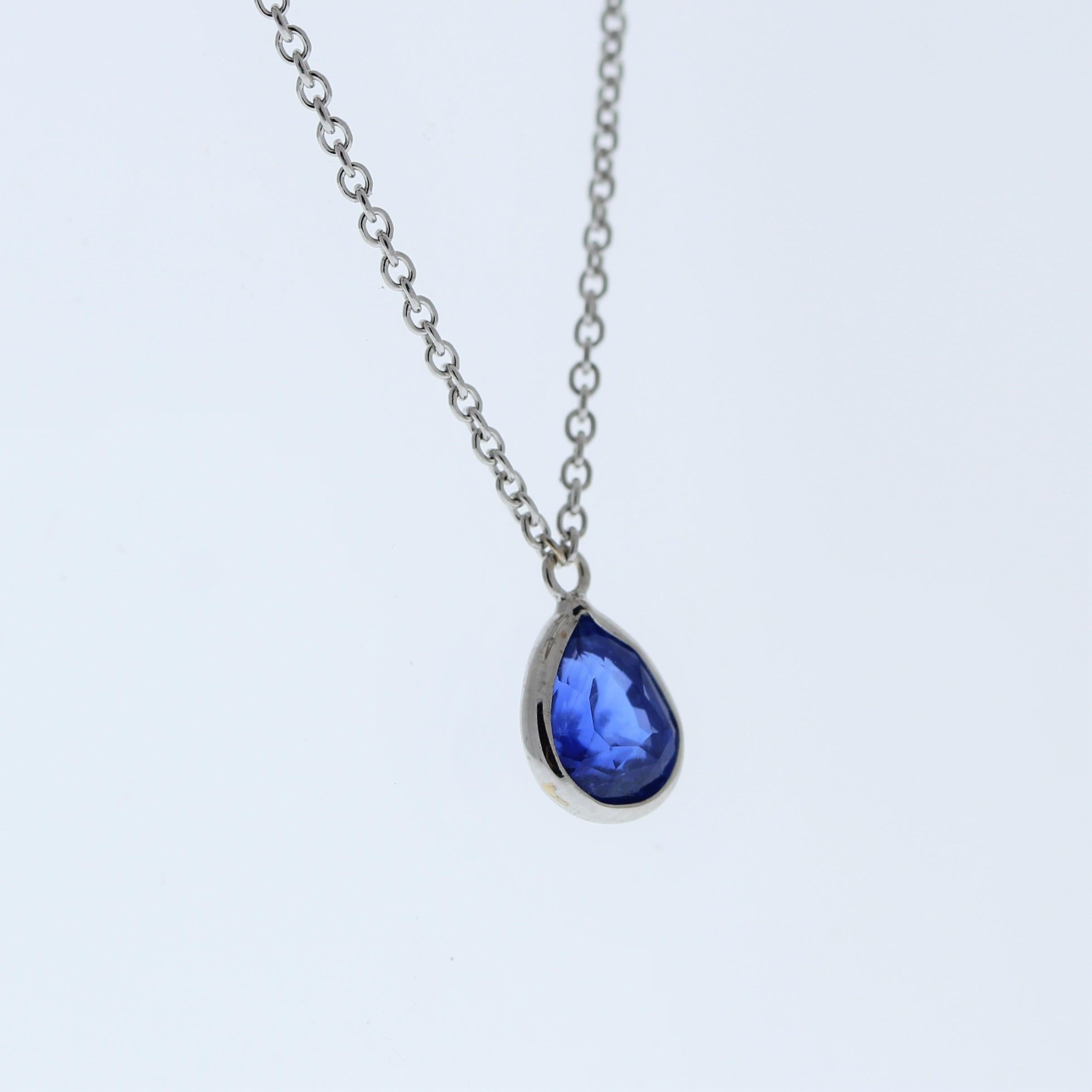 The necklace features a 1.49-carat pear-cut blue sapphire set in a 14 karat white gold pendant or setting. The pear cut and the blue sapphire's color against the white gold setting are likely to create an elegant and versatile fashion piece,