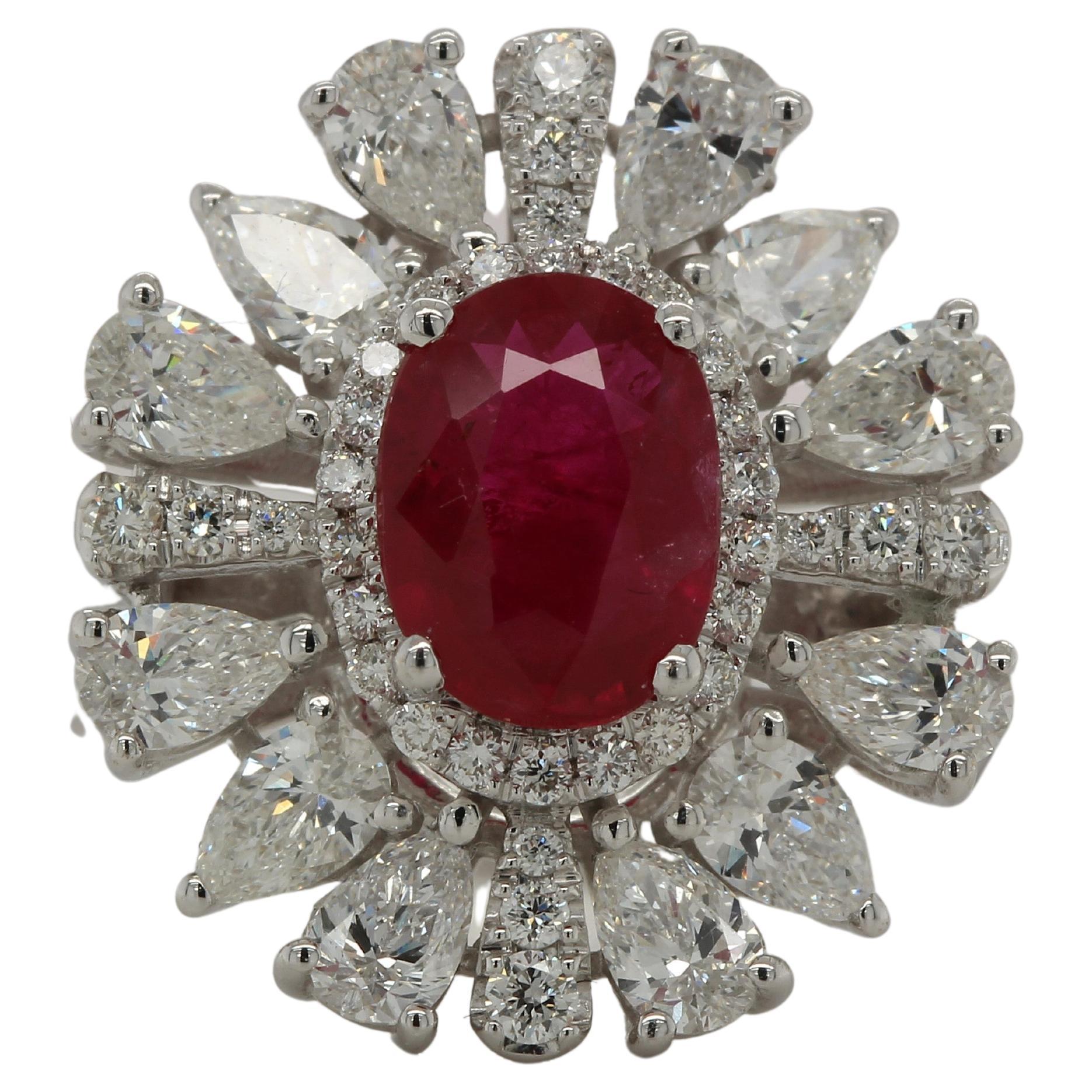 Our 1.49 carat oval ruby ring is a stunning masterpiece of elegance and simplicity. It showcases a single oval cut natural untreated ruby of the finest quality, set with 0.21 carats of white round diamonds and white pears 1.31 carats. This exclusive