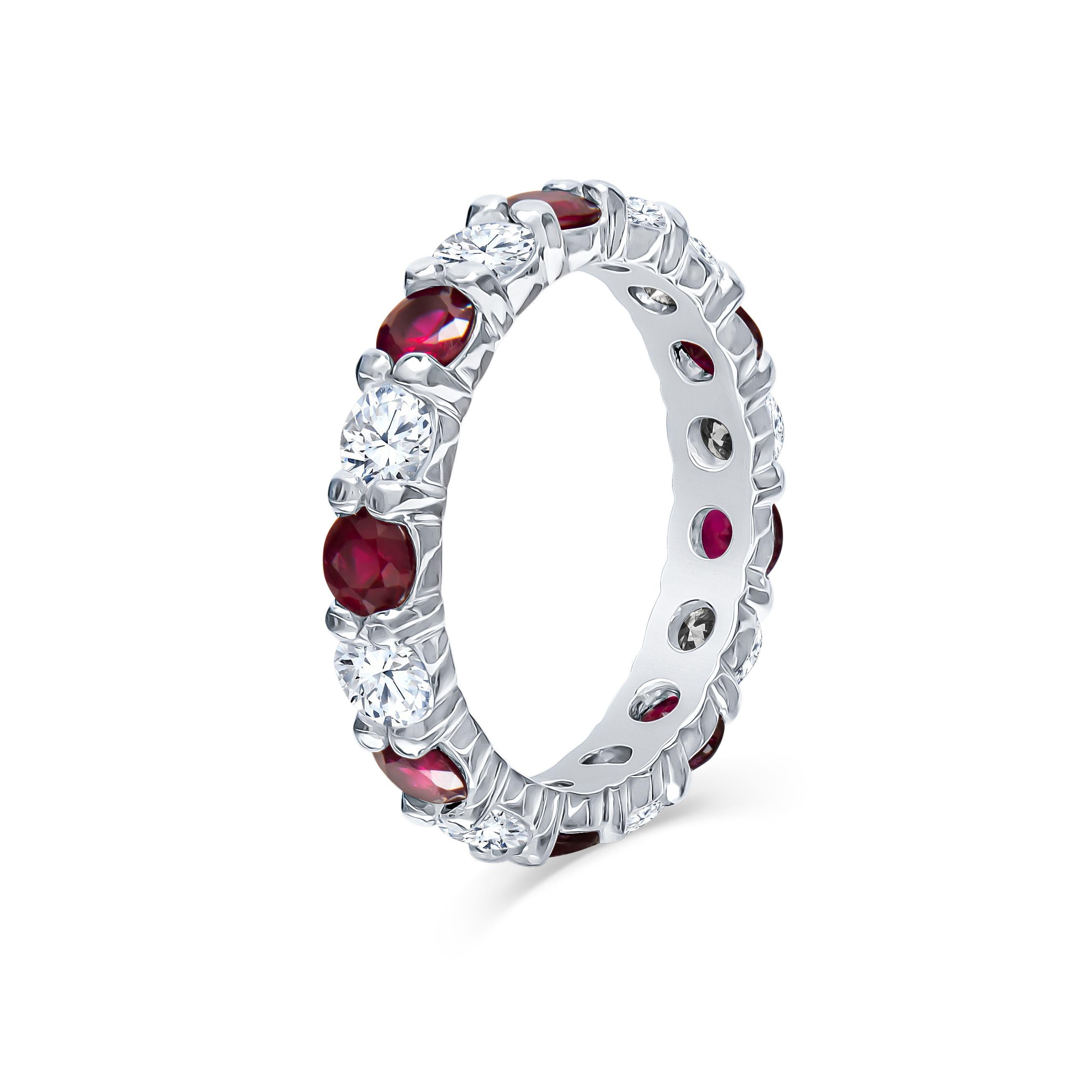 1.49 Carats total of fine round rubies and 1.53 carats total in round brilliant cut diamonds perfectly set into a platinum low profile eternity band. This band wears beautifully alone or stacked with other rings that compliment the hand. Currently a