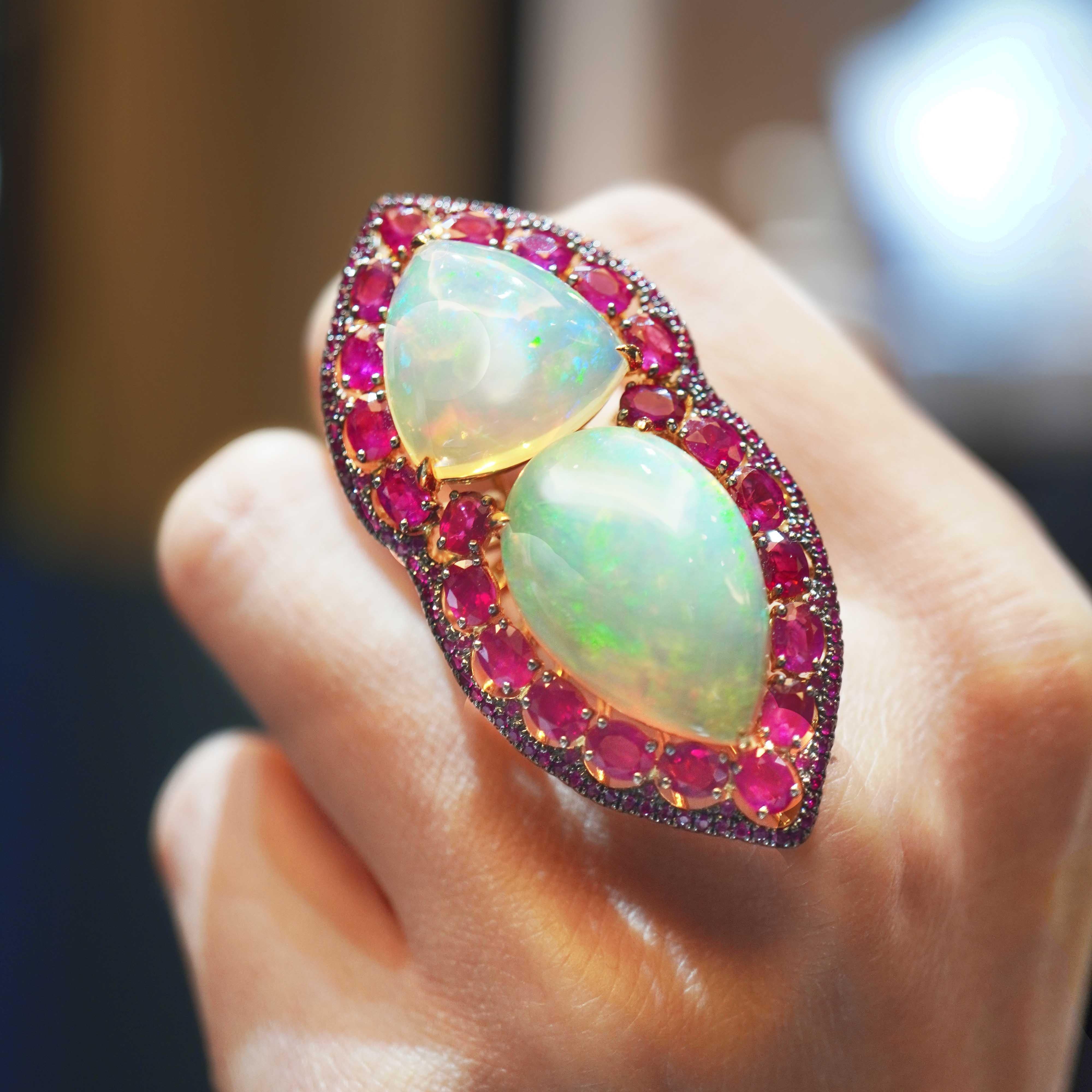 An artful combination of 14.90 carat of Ethiopian Opal and 5.67 carat of vivid red round Burma Ruby is set together in this One Of A Kind Cocktail ring. The ring has been made in 18K gold and is hand made. The total weight of 18K gold is 19.16