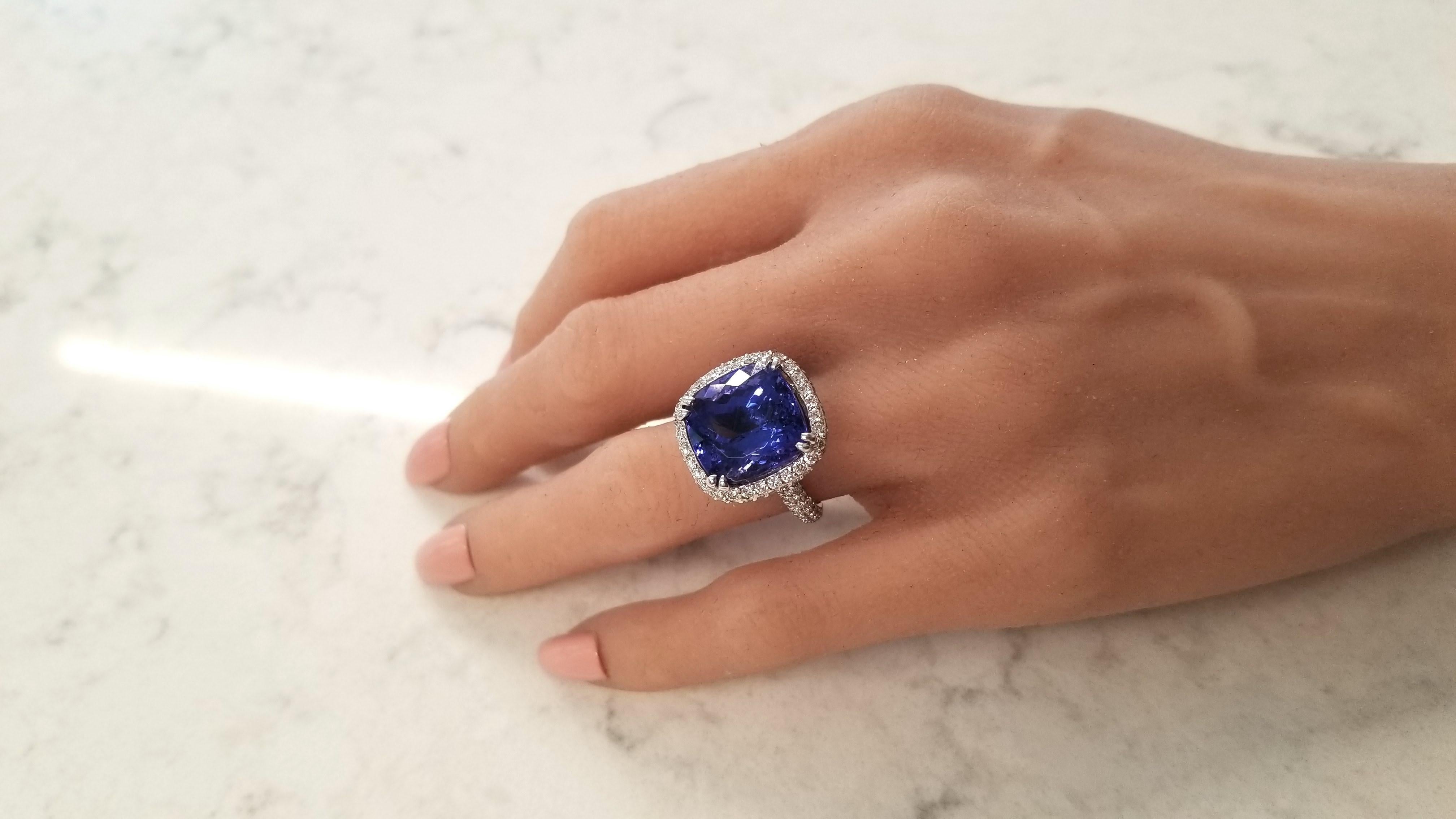 This is a 14.93 carat cushion cut fine quality intense bluish-violet tanzanite that measures 13.80 X 13.62mm in a secure double prong setting. The gem source is near the foothills of Mt. Kilimanjaro in Tanzania. Its color is vivid and vibrant; its