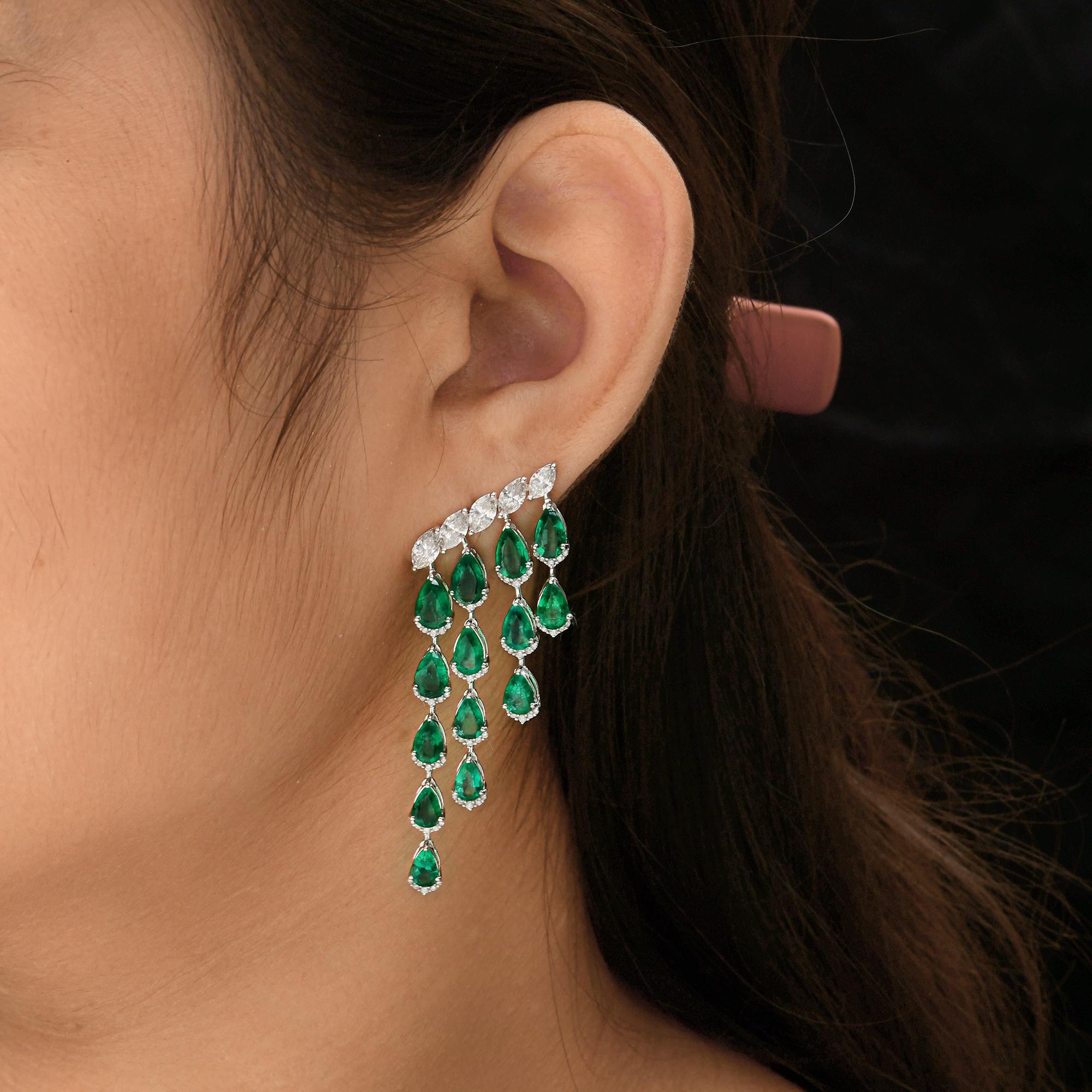 Exude elegance and sophistication with these stunning 14.98 Total Carat Weight (TCW) dangle earrings. Featuring a breathtaking combination of vivid green Zambian emeralds and sparkling round and marquise cut diamonds, these earrings are a