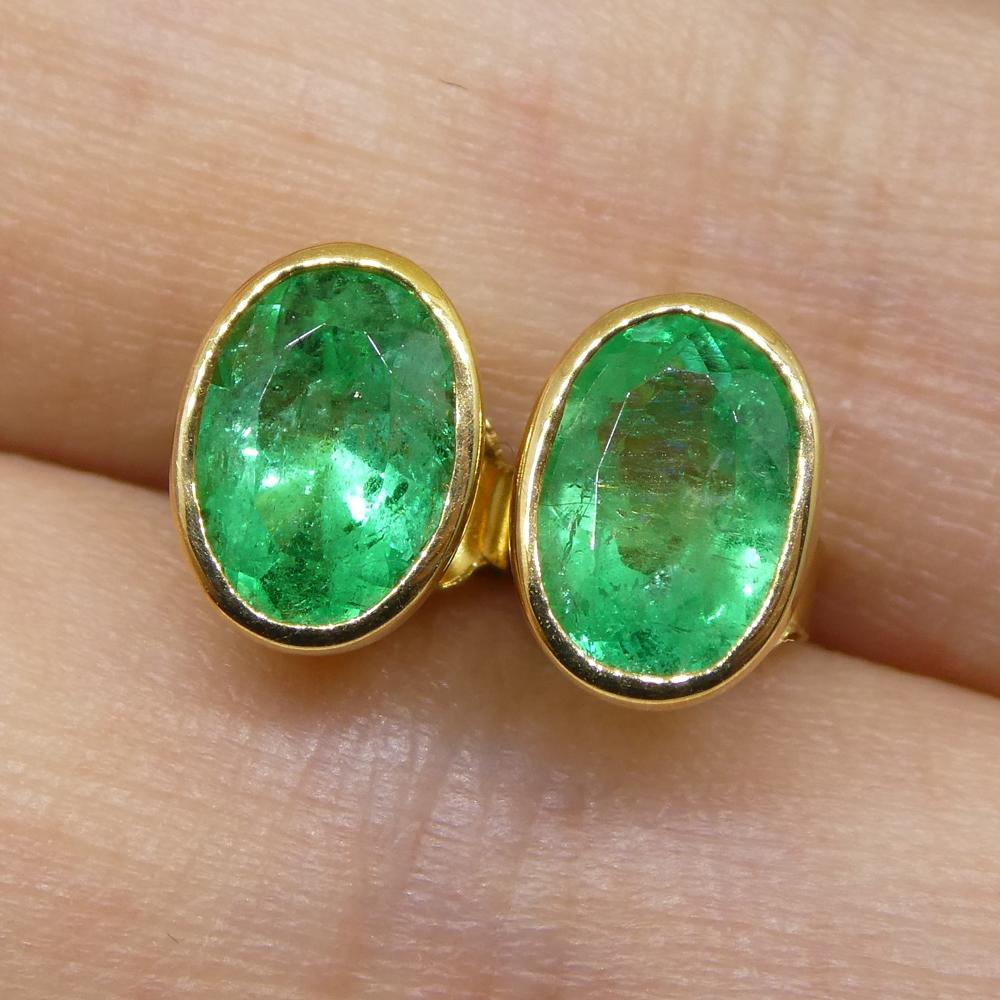 These two beautiful oval emeralds are bezel set in a pair of 18kt Yellow Gold stud earrings settings with butterfly backs.  

These are made in Toronto, Canada, and are incredibly fine quality!

****

Description:

Stone Type: Emerald
Number of