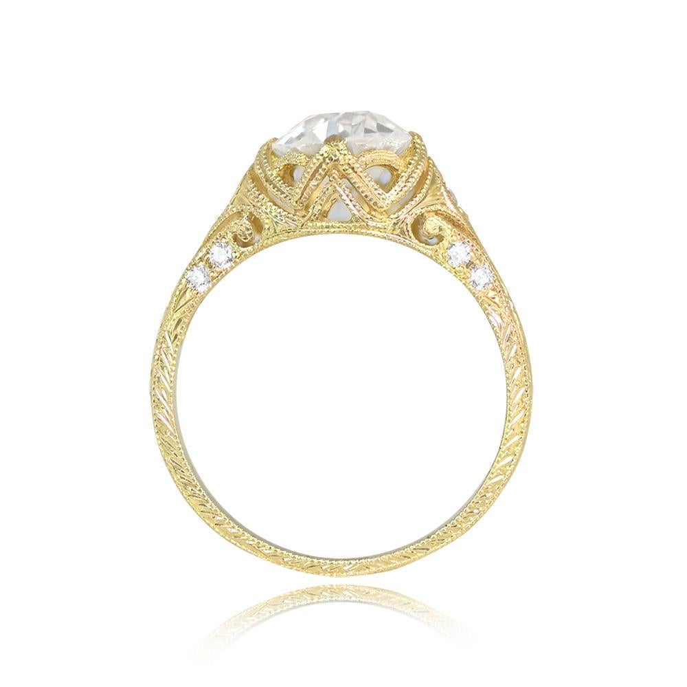 This stunning ring boasts a 1.49-carat old European diamond with J color and VS2 clarity, securely set in prongs. The 18k yellow gold openwork mounting is adorned with pave-set round brilliant cut diamonds. Hand engravings and fine milgrain add