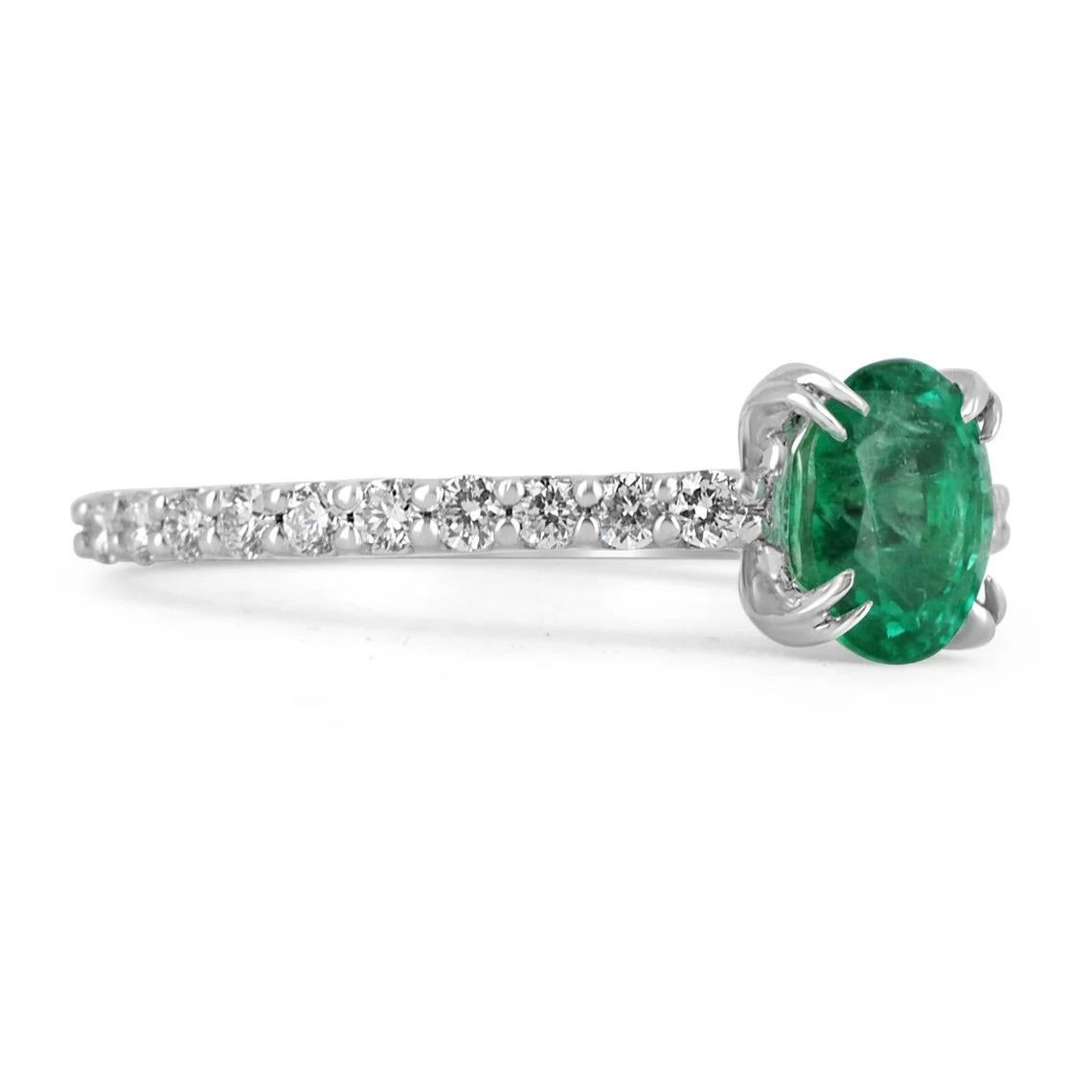 Elegantly displayed is a natural oval-cut emerald and diamond ring. The center gem is a beautiful quality, oval cut, emerald filled with life and brilliance! Among the emeralds, impressive qualities are their vibrant color and beautiful eye clarity.