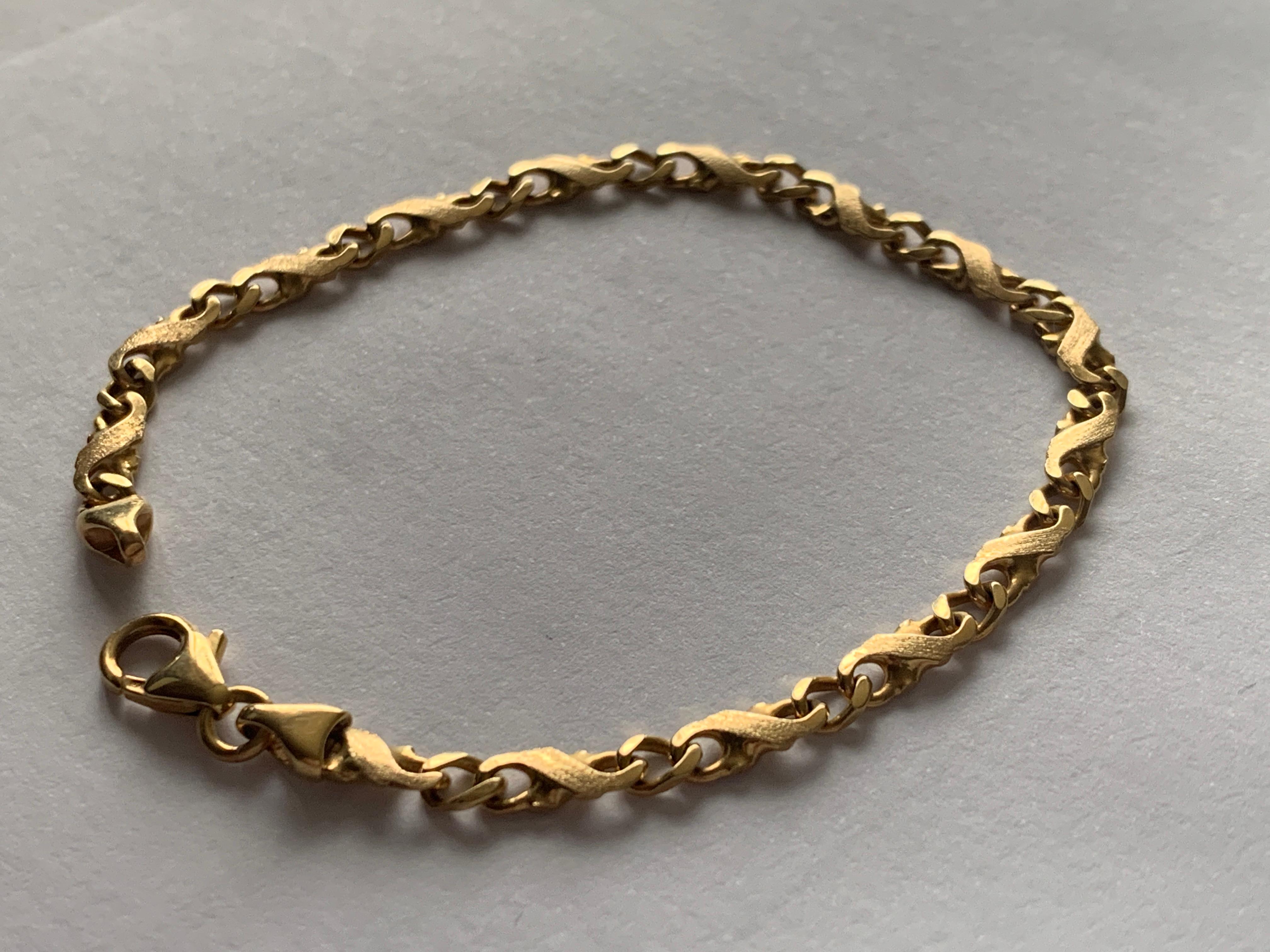 14ct 585 Gold Bracelet
with a beautiful link design that has a brushed 
naturalised design surface 
the links are solid gold - not hollow
the Gold colour is exquisite 
Polish stamp marks for 14ct Gold