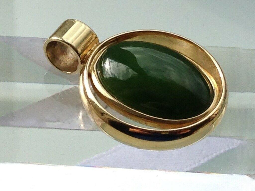 14ct 585 Gold Jade Pendant
Condition - Like new
Era 1950
Stamped and signed & dated ( within the inner rim  07/03/53
Goldsmiths mark - whale shape  and another mark with 585 also
Total Weight 8.68 grammes
Threading space of bail 4mm