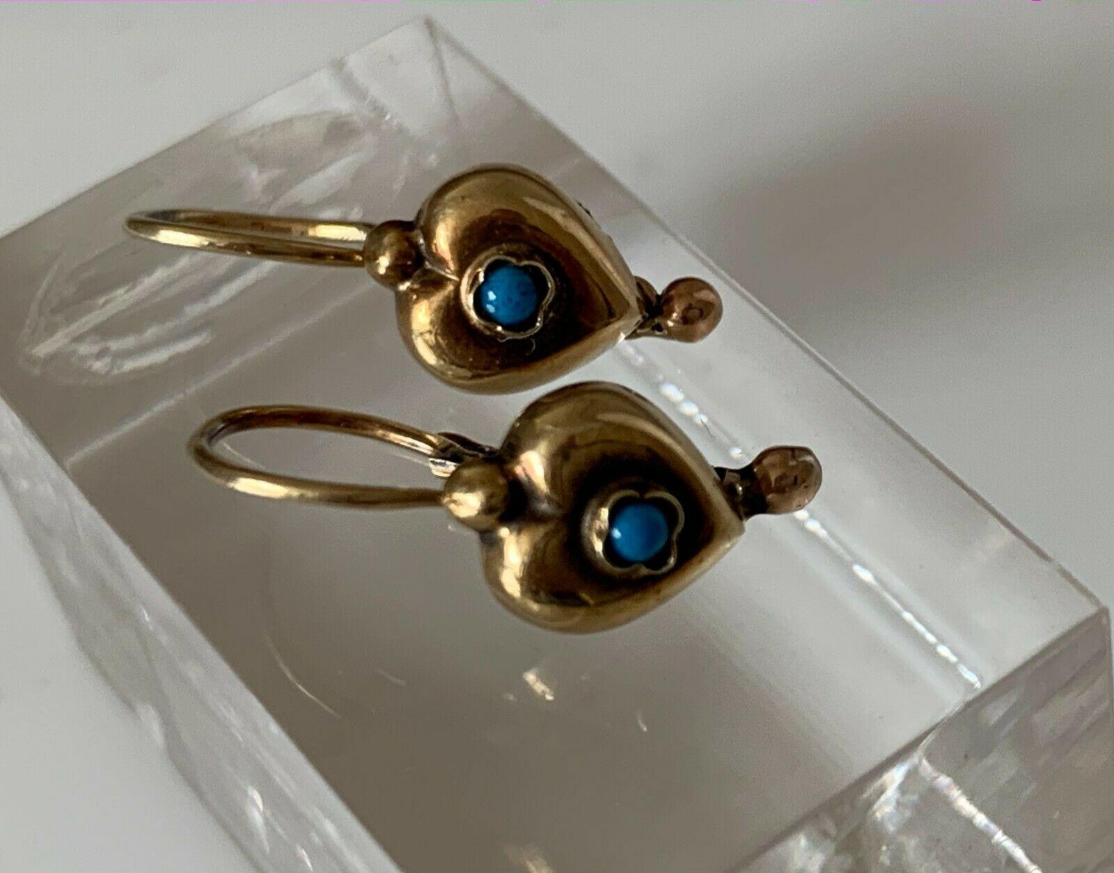14ct 585 Gold Vintage Petite Earrings
** Central stones are a blue Colour with darker flecks visible- unknown ** 
Stamped 585 & an unknown makers mark 
Era 1920s-30s
The Heart measures 7mm x 7mm x 3mm approx
with a dangling 2mm ball ball .
Actual