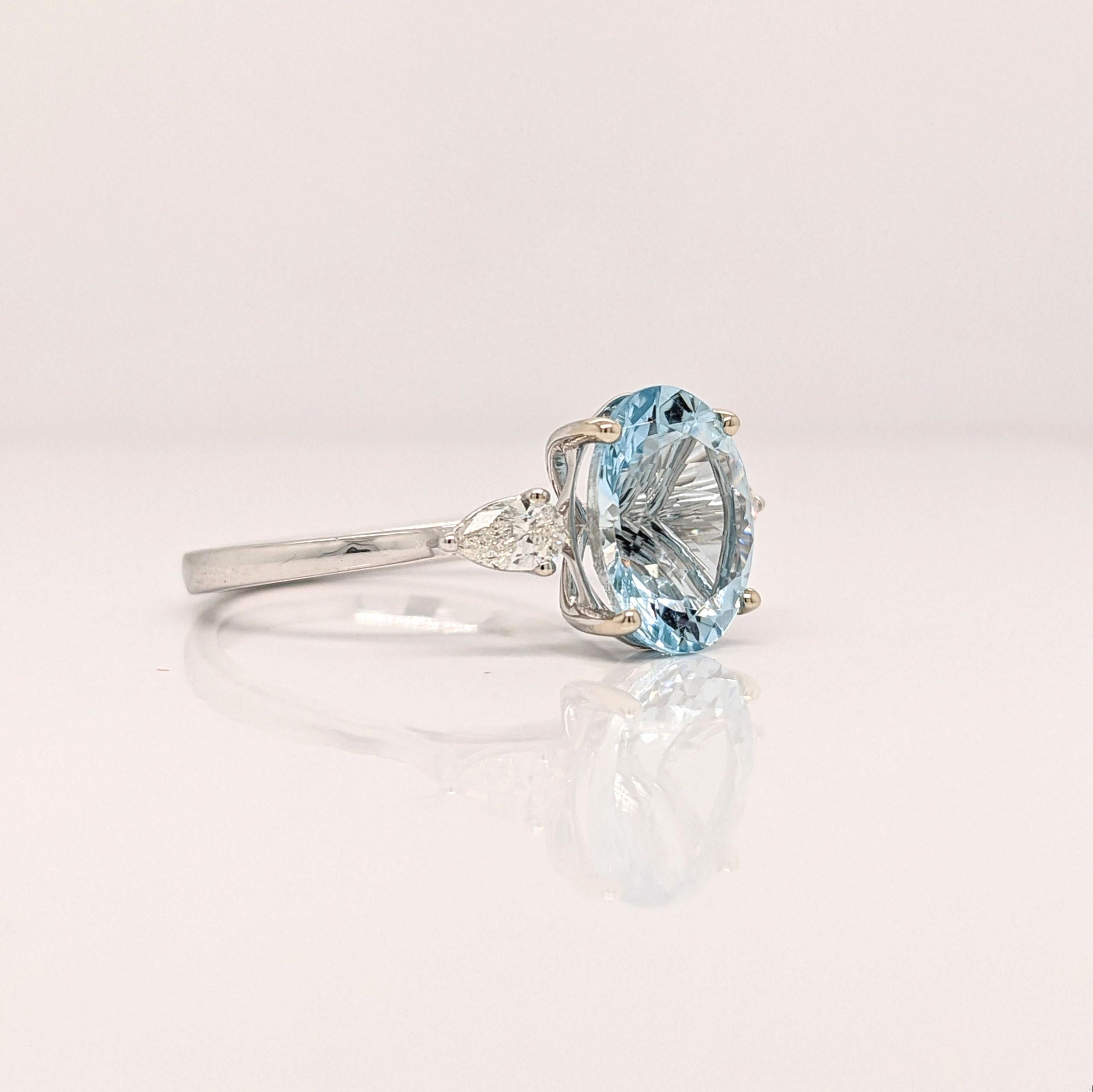 This beautiful 3 stone ring features a sparkling Aquamarine in 14k white gold and two pear diamond accents. A statement ring design perfect for an eye catching engagement or anniversary. This ring also makes a beautiful birthstone ring for your