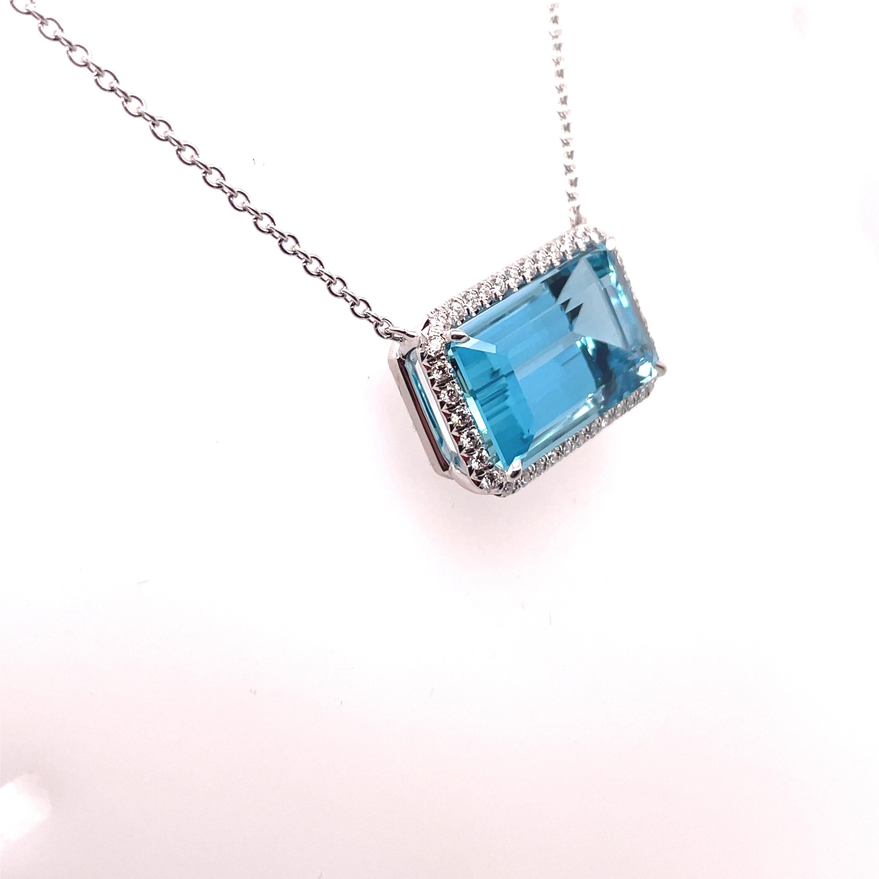 Absolutely studding 18kt white gold necklace featuring a stunning perfectly colored 14.30ct aquamarine surrounded by 38 round brilliant cut diamonds for a total of .37cts. This necklace can be secured at two separate lengths to make sure it hits at
