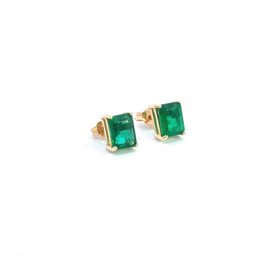 Presenting our exquisite 1.45ct Emerald Stud Earrings crafted in lustrous 18k yellow gold. The focal point of these earrings is the stunning pair of 1.45ct natural emeralds, each skillfully cut into an elegant emerald shape. The prong setting