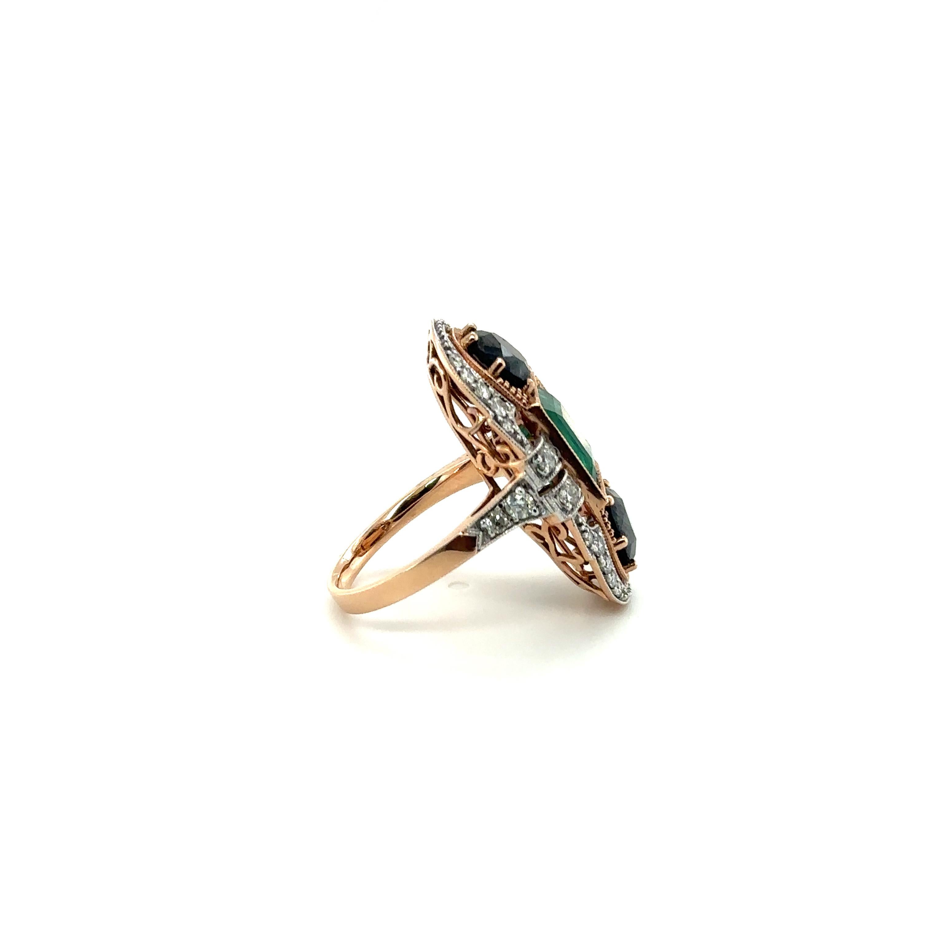 One ladies - art deco style 14ct rose gold dress ring, tapered shank with open back claw and rub over settings, polished finish. The item contains:

One rub over set emerald cut emerald, colour is 