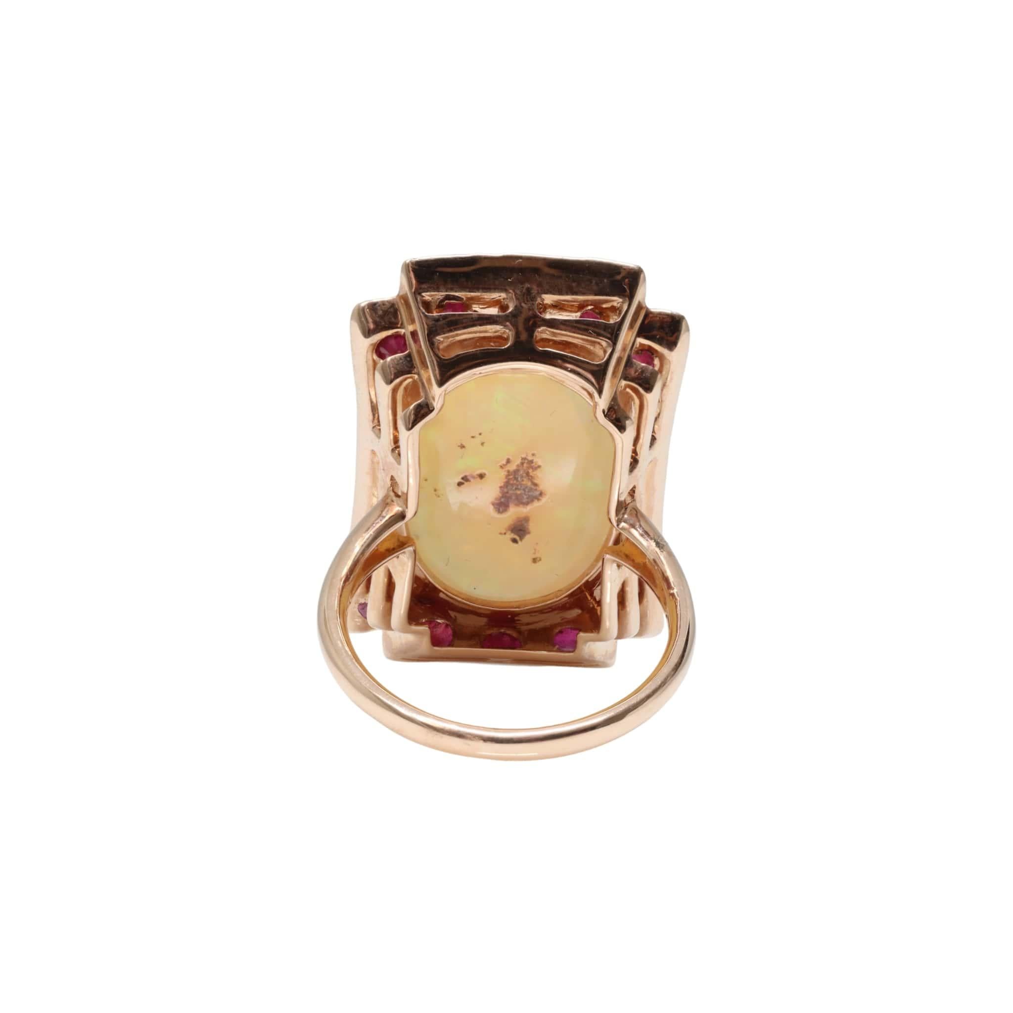 One ladies - 14ct rose gold dress ring, narrow, high half round, tapered shank with open back, 4 claw setting, polished finish. The item contains:

One claw set oval crystal opal cabochon, with orange, green play of colours.

Dimensions = 19.3mm(L)