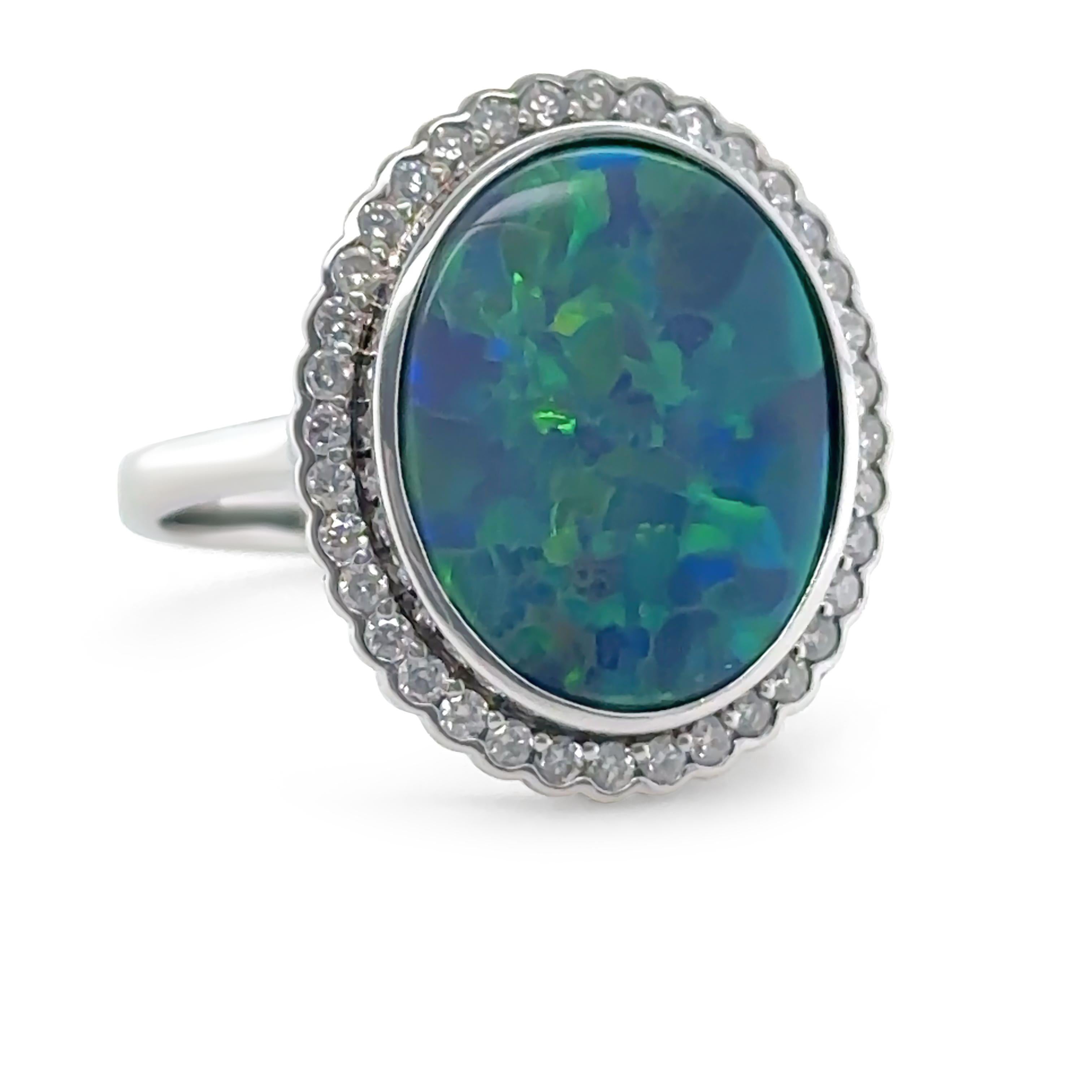 An extraordinary opal and diamond dress ring, meticulously crafted in 14ct white gold with a polished finish. This statement piece features a vibrant black doublet opal sourced from Lightning Ridge, Australia.

The cabochon-cut opal (18.05 x 12.52 x