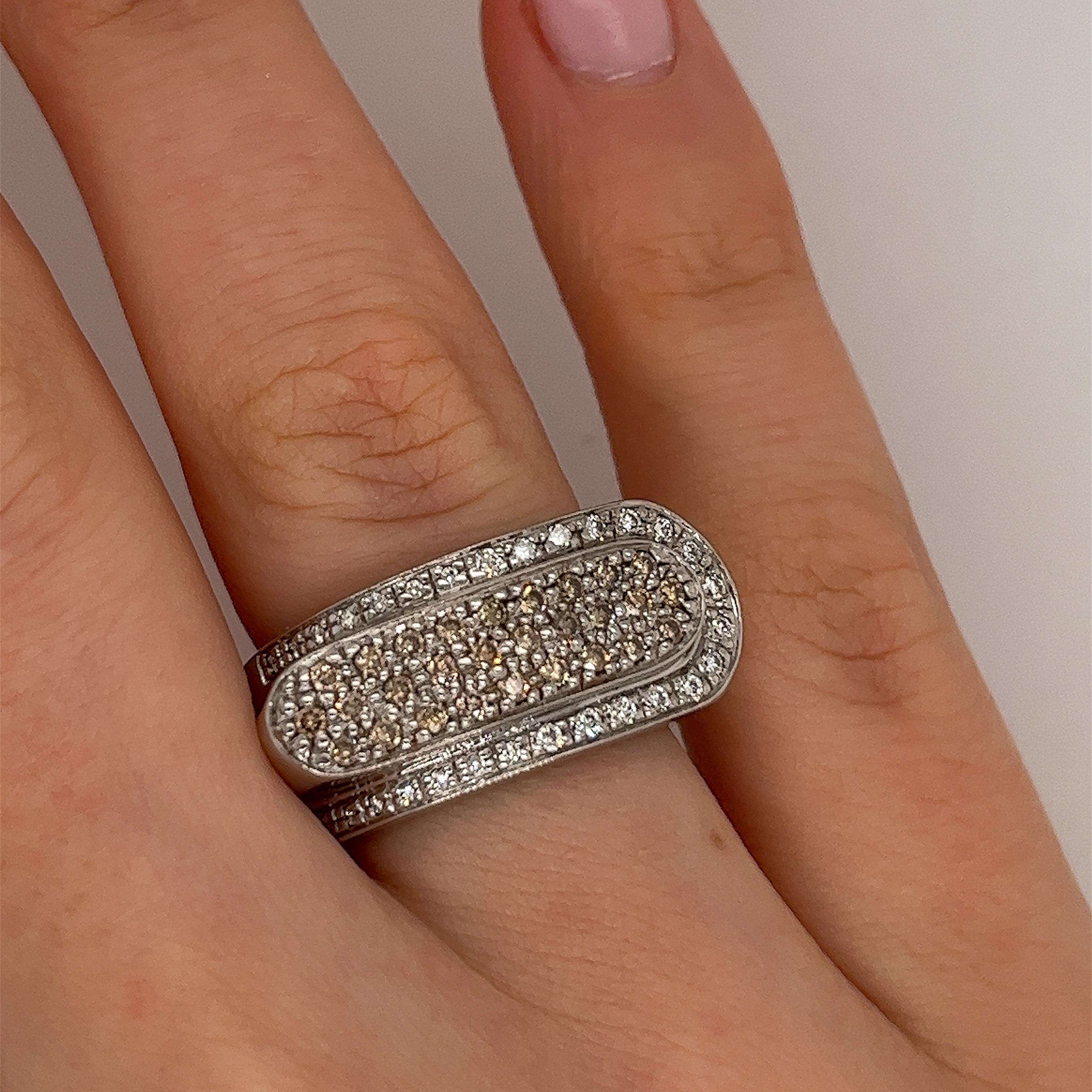 An elegant diamond pre-loved dress ring, set with 0.60ct round brilliant cut natural diamonds, a mix of white and brown diamonds, in a 14ct white gold setting.

Total Diamond Weight: 0.60ct
Diamond Colour: G / brown
Diamond Clarity: VS1
Width of
