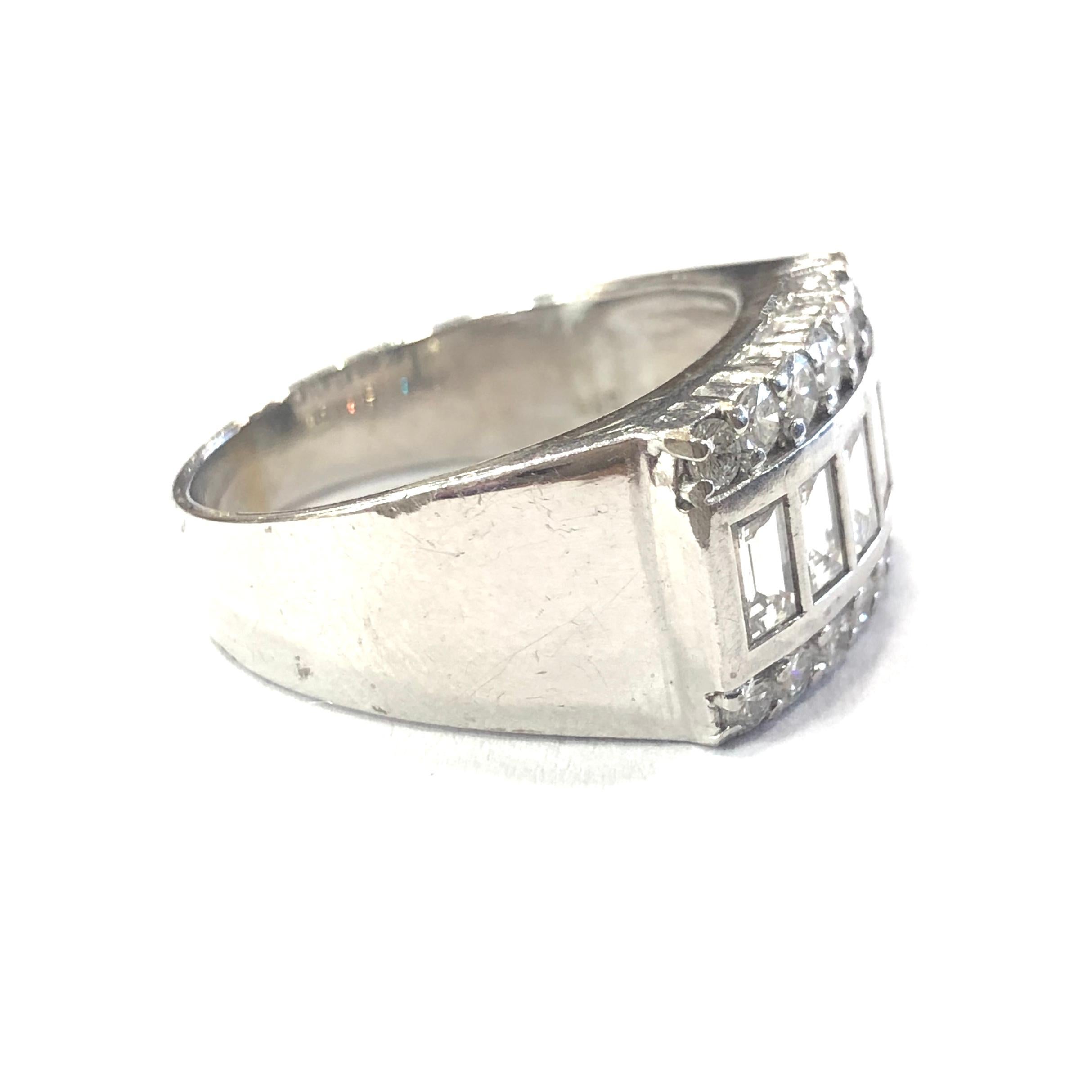 14ct White Gold Diamond Unisex Chunky Ring. Set with five central Baguette Diamonds in a rubover setting, and two rows of seven round brilliant cut Diamonds either side in a peg setting. 

Approximate total Diamond weight : 2.50ct
Total weight :