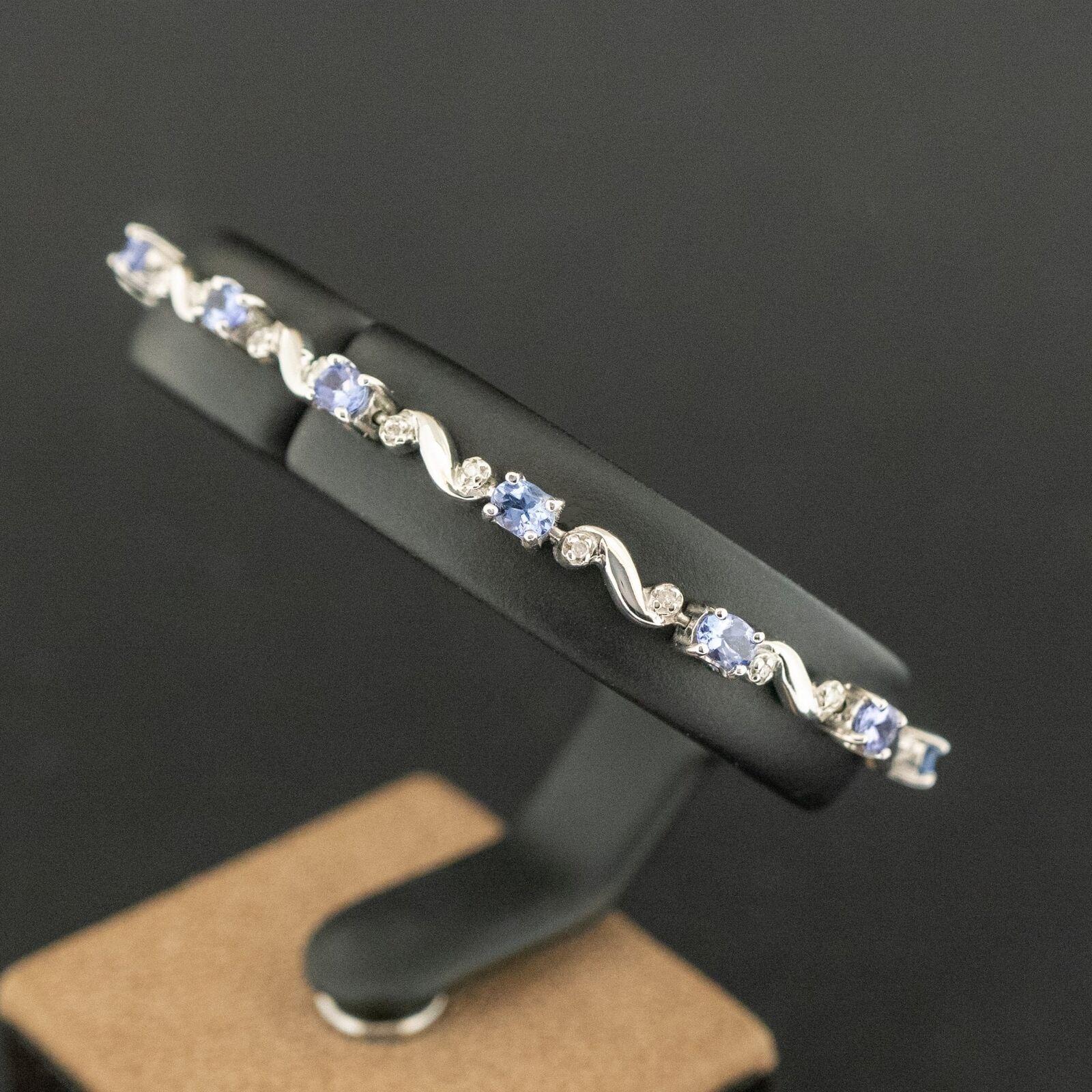 Condition: Pre-owned. Good with mild/light scratches
Material: 14ct White Gold
Hallmarked: Stamped 14K. Tests as 14ct
Main Stone Identity:  Tanzanite
Main Stone Colour:  Purple/Blue
Main Stone Total Carat Weight:  Approx. 2.17ct
Secondary Stone