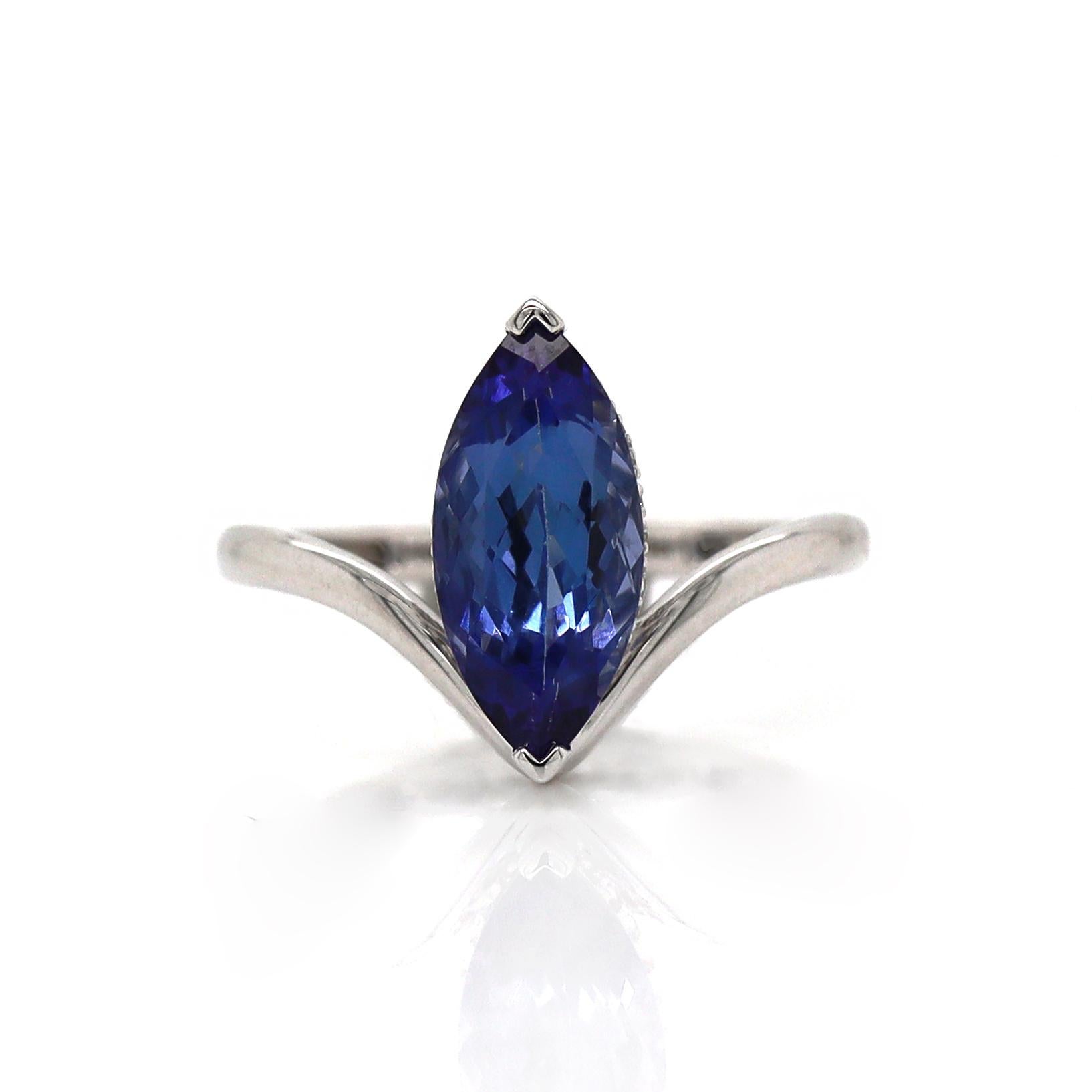 14CT White Gold Tanzanite And Diamond Dress Ring

This 14ct white gold ring features a stunning marquise-cut purplish-blue tanzanite, set in a sleek V-shaped mount. Below the gemstone, a delicate diamond bridge adds sparkle and elegance, enhancing