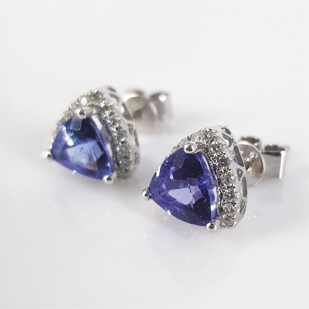 This Stunning pair of Studs are set in 14carat White Gold weighing 1.9grams. They feature 2 Trillion Cut Tanzanite’s weighing 0.80 carat each and 36 Round Brilliant Cut Diamonds weighing 0.18carat in total.