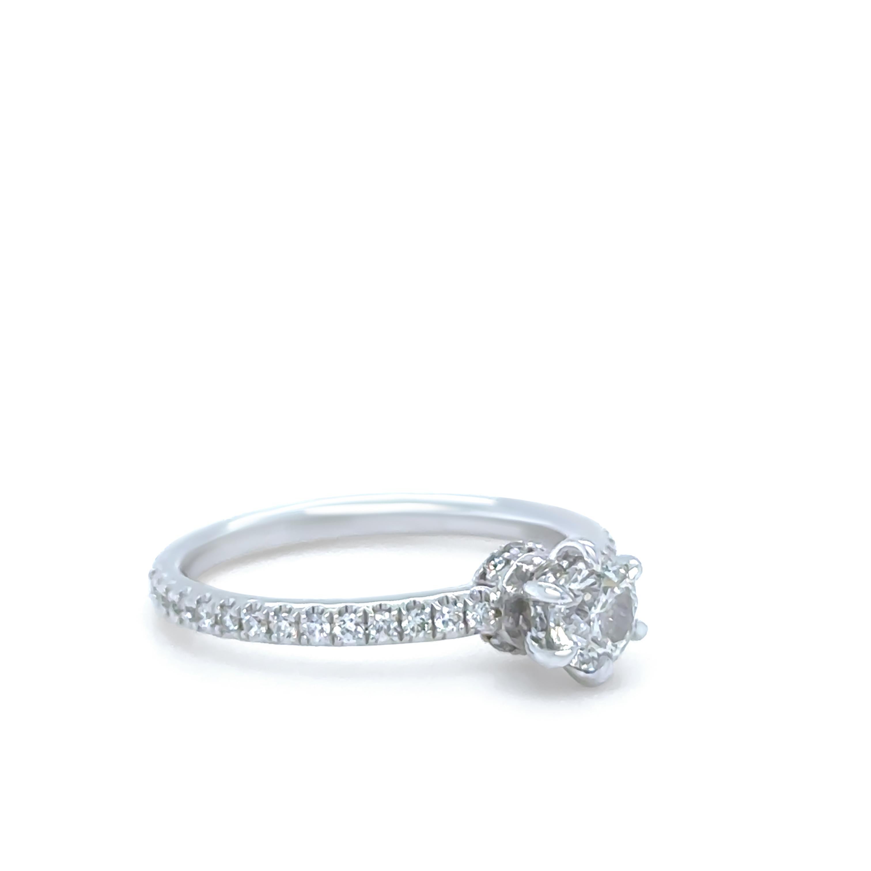 This beautifully designed Michael Hill halo engagement ring is crafted in 14ct white and rose gold, featuring a CAD-drawn, cast and hand-finished multi-piece mount. At its centre is a certified 0.45ct round brilliant-cut diamond, H/I colour and I1
