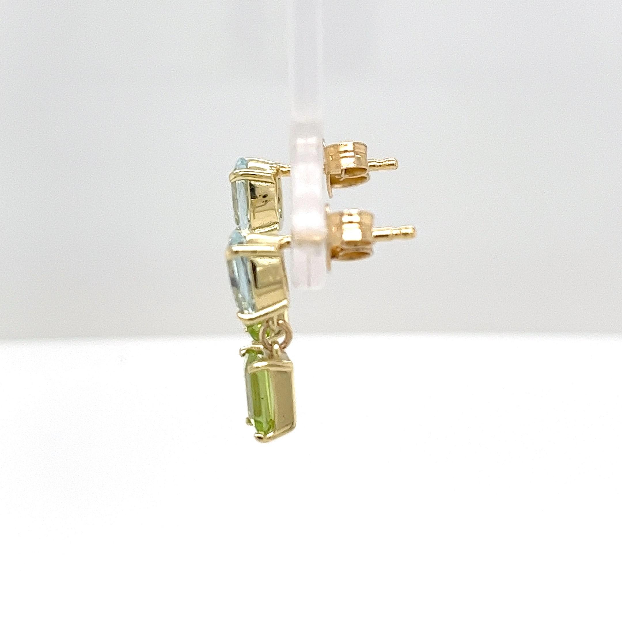 Beautifully crafted 14ct yellow gold drop earrings featuring rich, deep aquamarine and peridot gemstones. These classic earrings bring elegance and a touch of luxury, ideal for any occasion.

Total Weight: 2.76g
Earrings Size: 15.65mm x