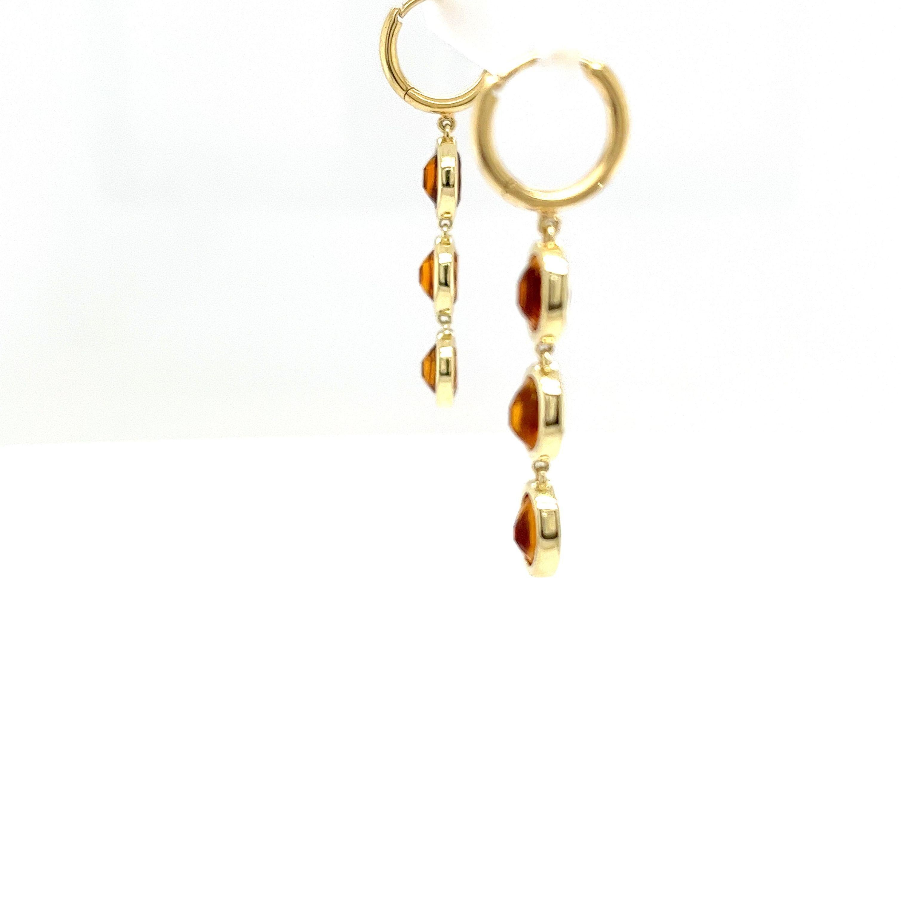 These elegant drop earrings are set in 14ct yellow gold and feature citrine gemstones, known for their warm, golden hue.  The stones are carefully cut and polished to showcase their natural brilliance. 
The simple yet sophisticated design makes