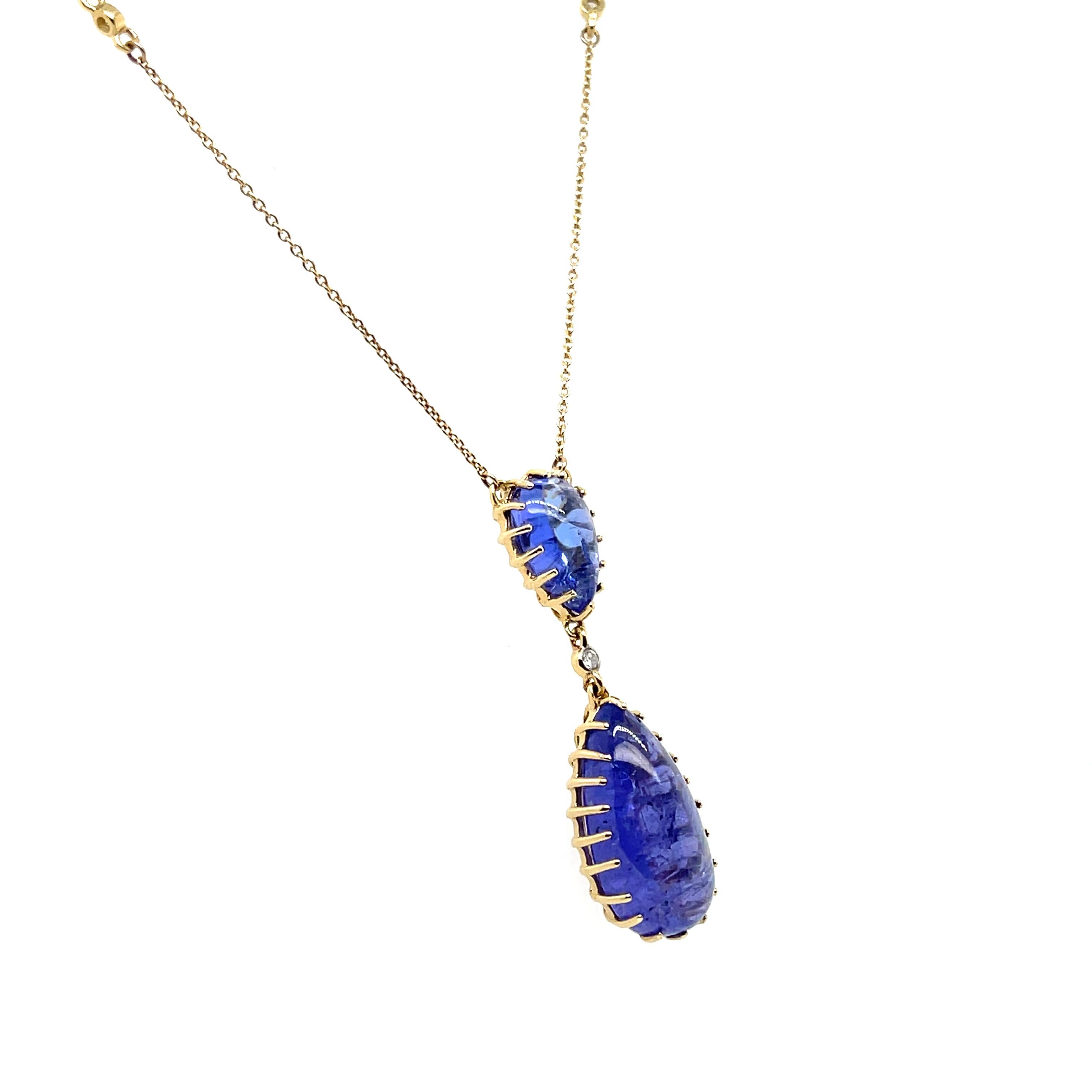 Beautifully designed 14CT YG double drop pear shaped Tanzanite pendant/necklace with an elegant touch set of round brilliant cut diamonds, polish finished with parrot clasp. 

Tanzanite Cabochons Weight: 12.55ct 
Dimensions: 10.7mm(L) x 6.8mm (W) x