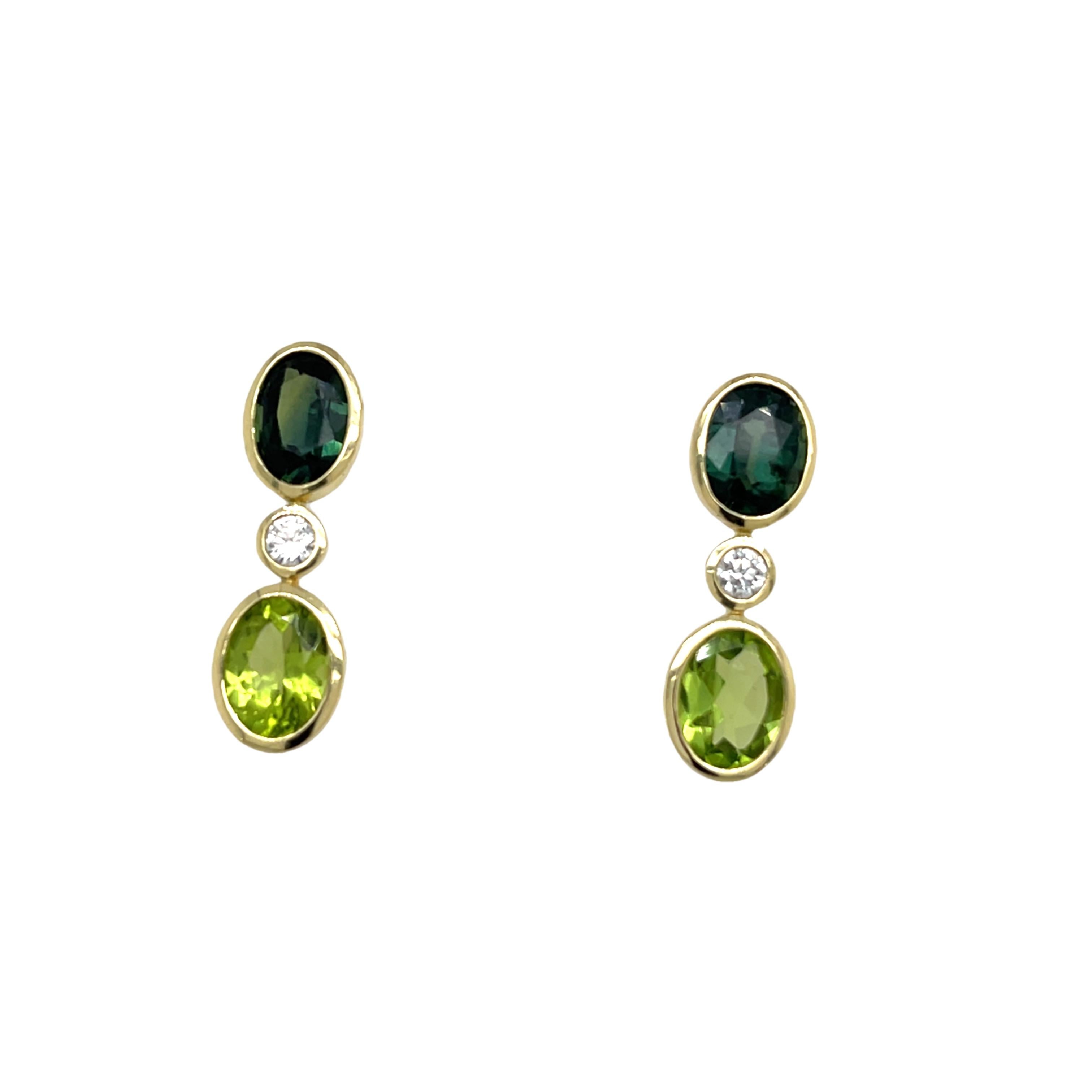 Elegant drop earrings in 14ct yellow gold, showcasing stunning green sapphires and peridot gemstones
accented by sparkling diamonds.  A graceful blend of colour and brilliance.

Total Diamond Weight: 0.14ct 
Diamond Colour: H
Diamond Clarity: