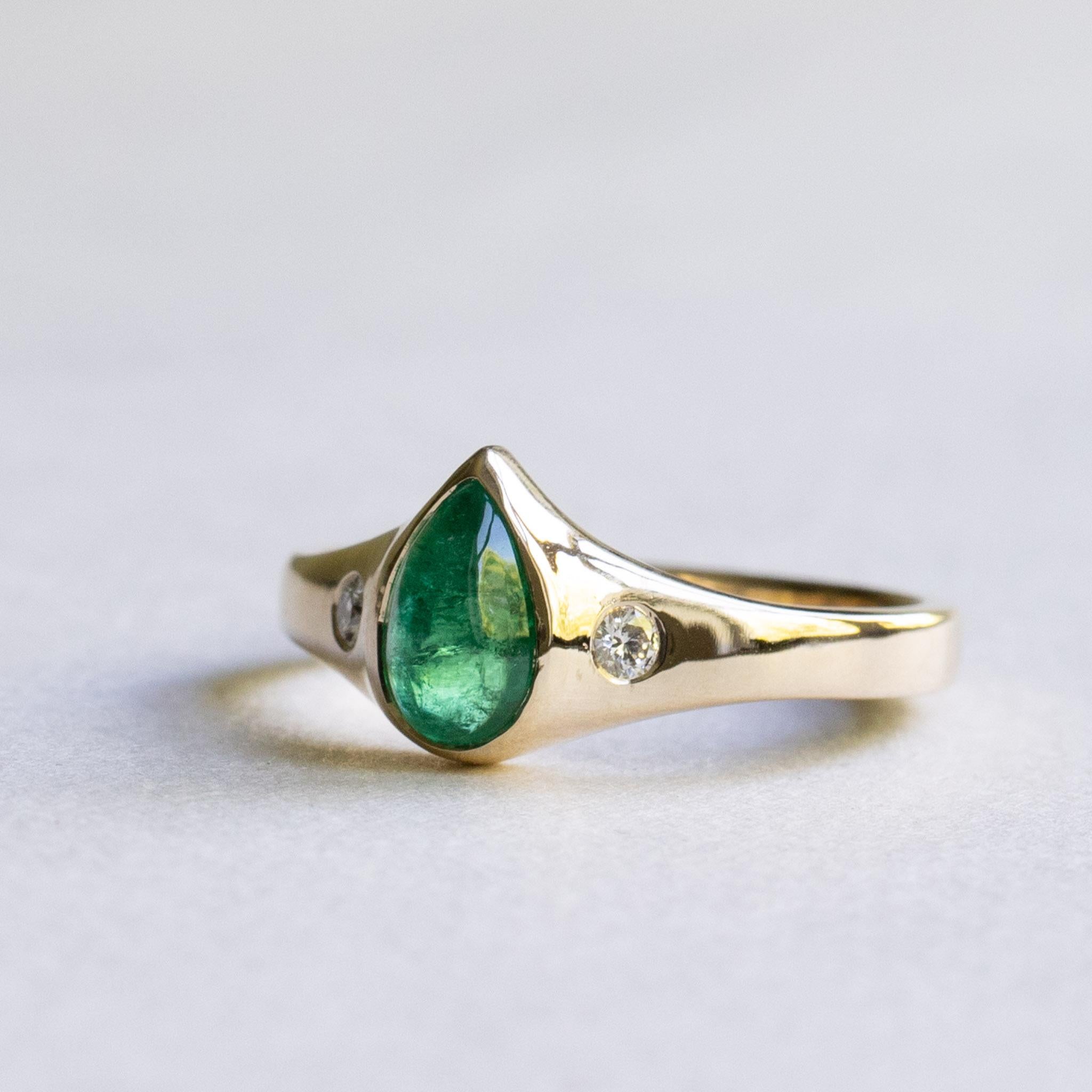 One-of-a-kind pear shape emerald on 14k yellow gold. 

Metal: 14k Gold
Stone: Zambian Emerald 
Stone Shape: Pear Cabochon 
Stone Weight: 0.85 Carat
Accent Stone: 2mm Natural Diamond
Accent Color and Clarity: GH, SI
Diamond Stone Weight: 0.06 Carat