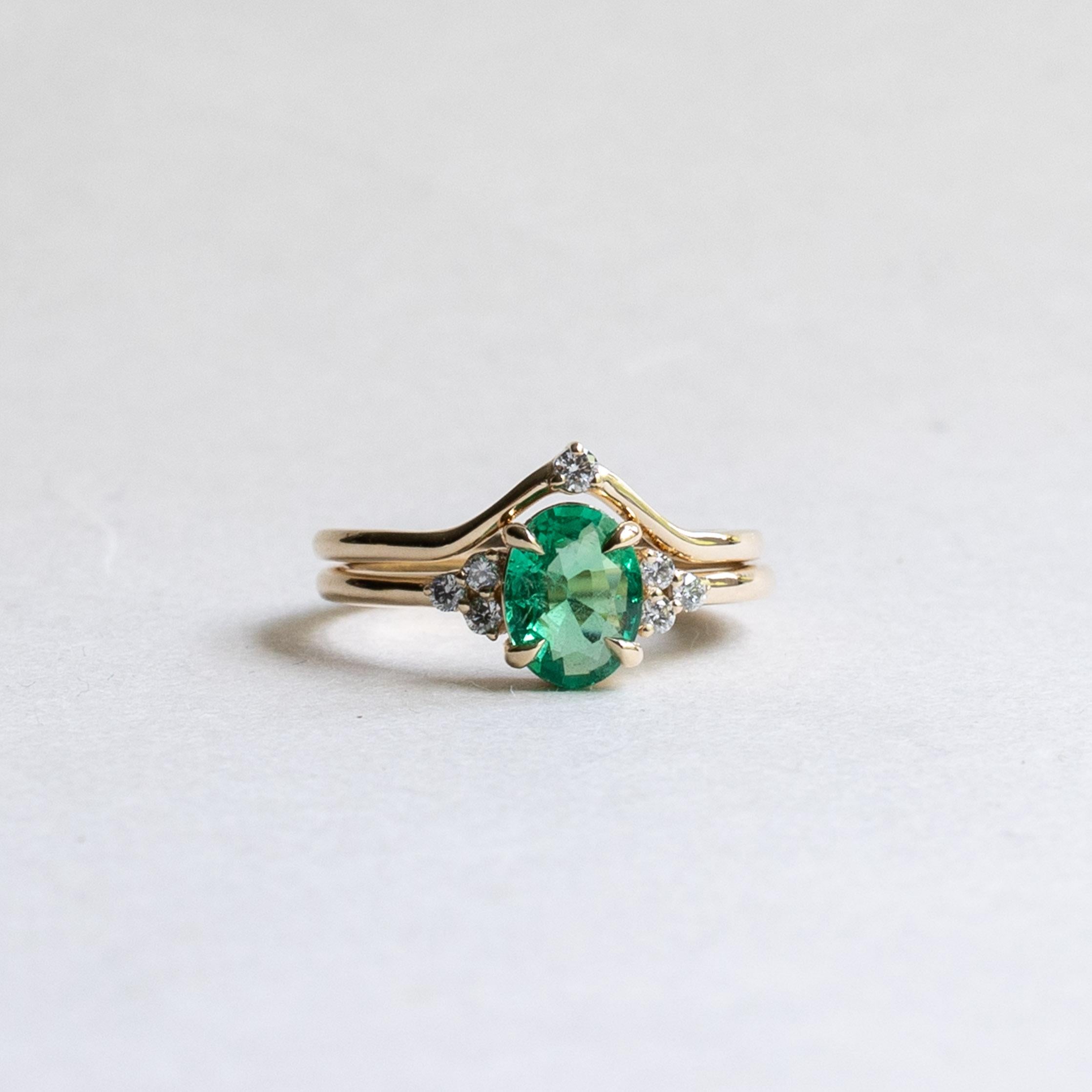 Metal: 14K Yellow Gold
Stone: Natural Zambian Emerald
Stone Weight: 1.13 carat
Accent Stones: Diamonds
Diamond Color and Clarity: G+, VS
Diamond Weight: 0.2 total carat weight
Band Width: 1.6mm