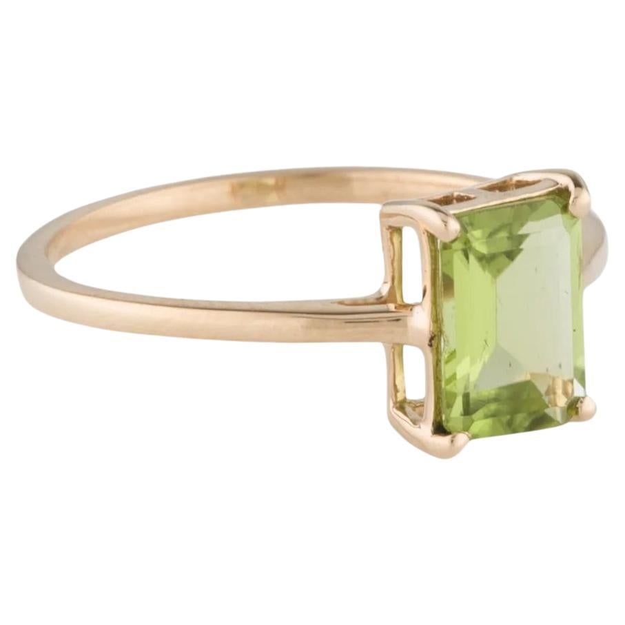 Indulge in timeless elegance with this stunning 14K Yellow Gold Peridot Cocktail Ring. Featuring a captivating 1.50 Carat Cut Cornered Square Step Cut Peridot, this ring exudes a vibrant green hue that is sure to turn heads. Crafted with meticulous