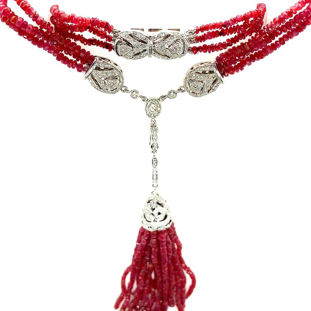 A multi-strand ruby necklace containing 163 carats of bright red faceted genuine ruby beads accented by 14K white gold and diamonds. It measures 21