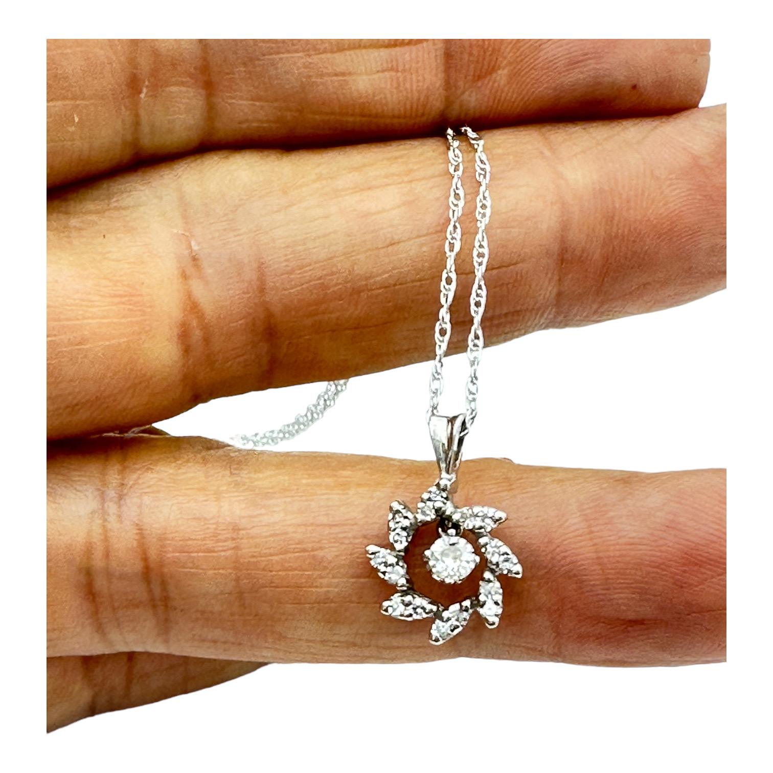 This 14K 1970's Halo Diamond Sweet Pendant is the perfect choice for any jewelry collection. It features a timeless diamond halo design for a sleek and classic look. Crafted with premium 14K gold, it is sure to become a cherished family