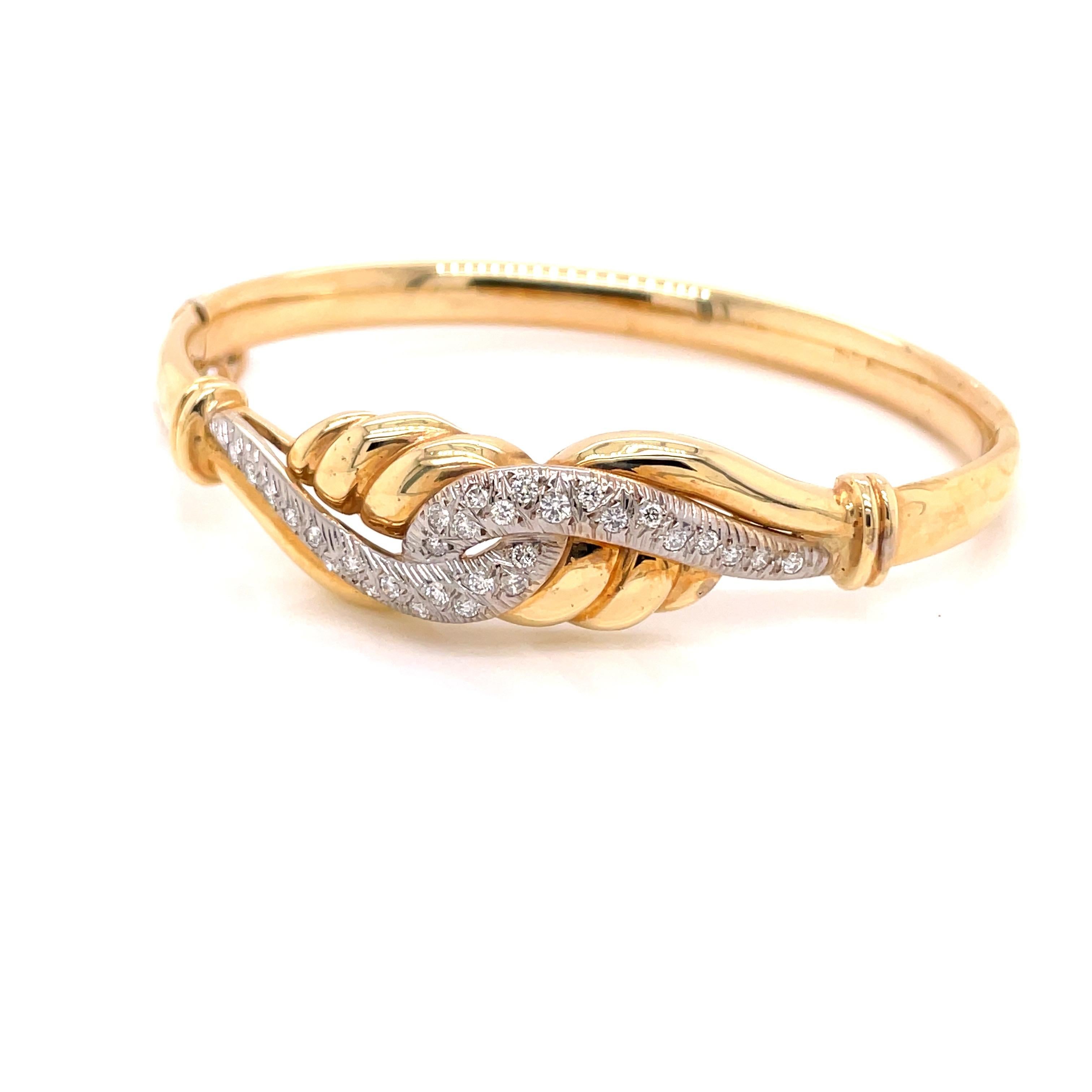 14K 2-Tone Gold Diamond Embrace Bangle Bracelet .50ct - The bangle is set with 30 round brilliant diamonds in white gold weighing approximately .50ct with G - H color and SI clarity. The width of the bangle is 14mm on top and tapers to 5.9mm on the