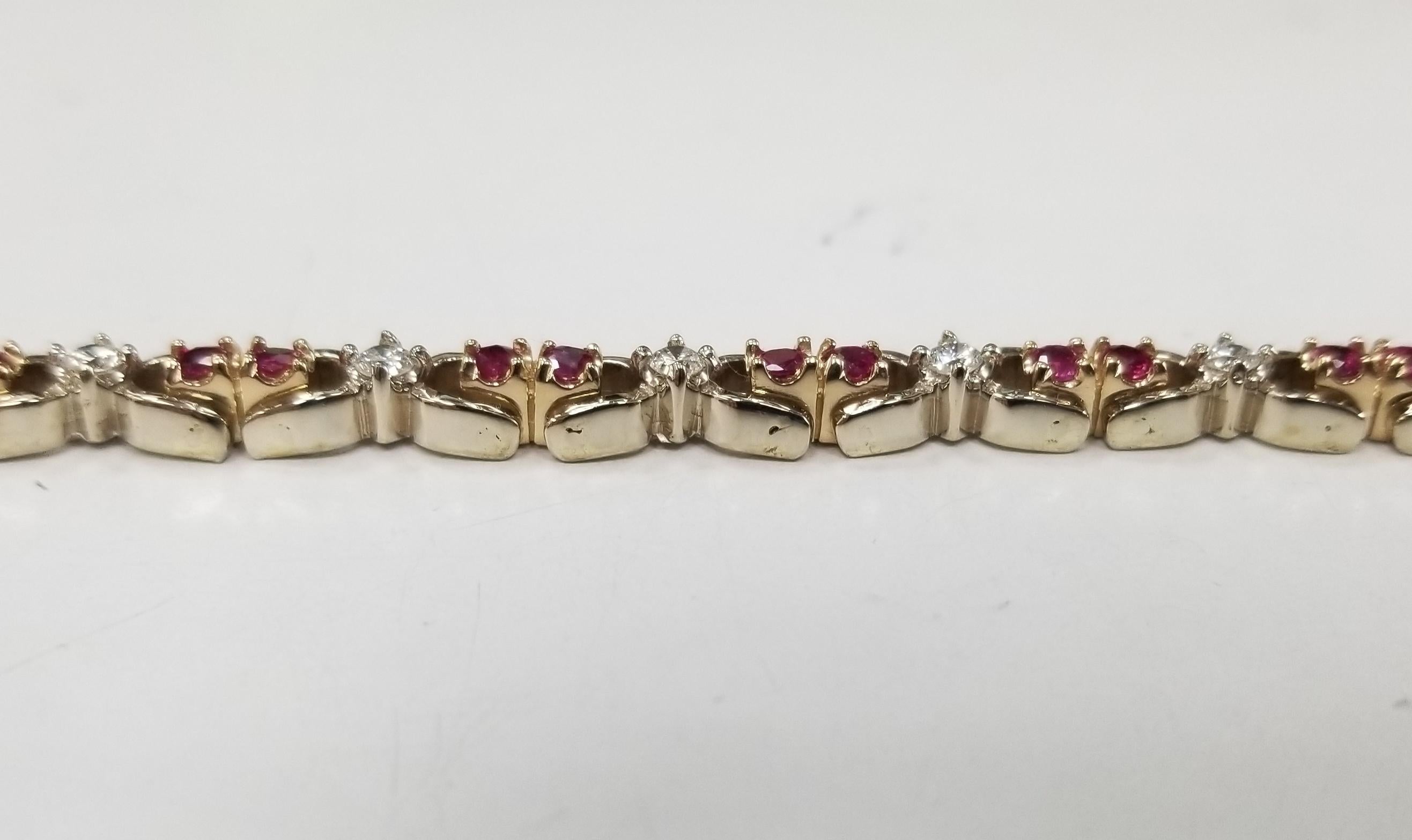 14k 2 tone gold ruby and diamond bracelet, containing 30 round rubies of gem quality weighing 2.79cts. and 15 round full cut diamonds; color 