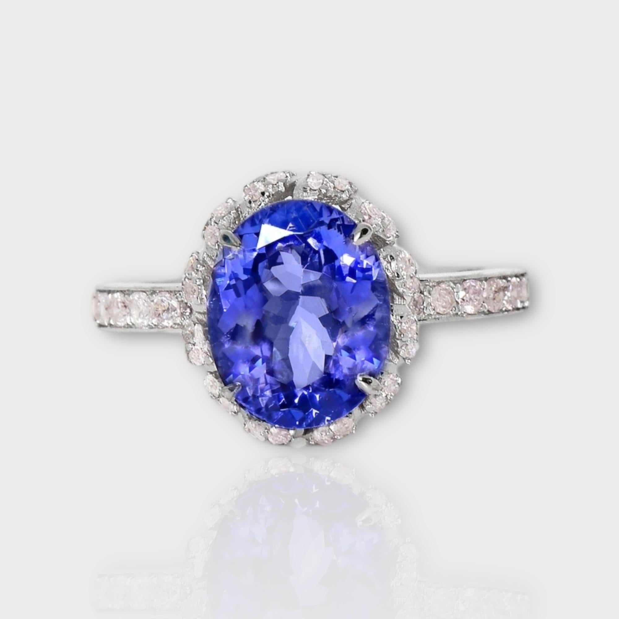 *14K 2.67 ct Tanzanite&Pink Diamond Antique Art Deco Style Engagement Ring*
The natural intense bluish violet tanzanite, weighing 2.67 ct, is the center stone surrounded by natural pink diamonds weighing 0.42 ct on the 14K white gold halo design