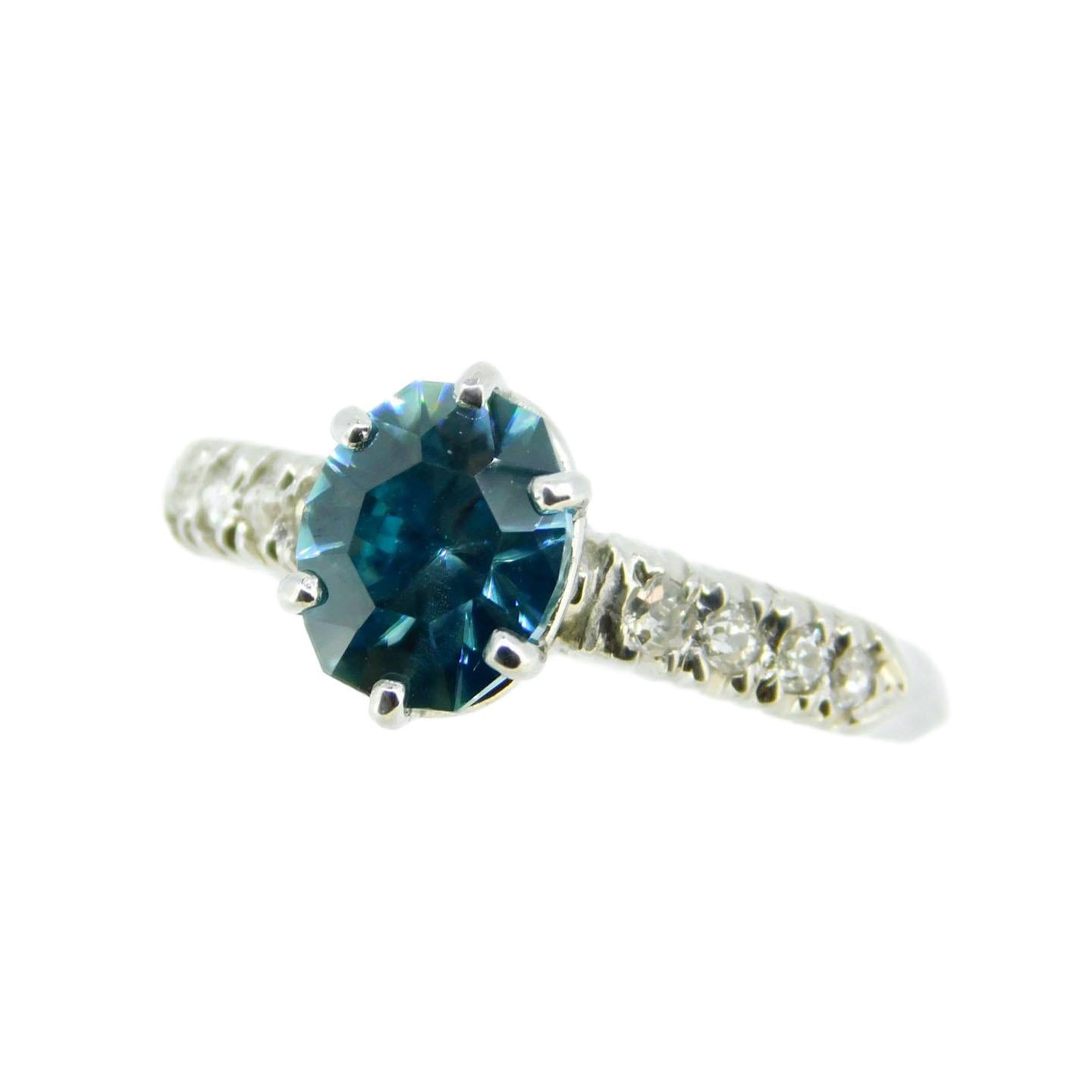 14K white gold ring featuring a specialty cut blue zircon weighing 2.88 carats. The zircon is a brilliant cut 8 sided oval with deep greenish-blue color. Blue zircon is a natural mined stone found primarily in Cambodia. Zircon has a high refractive