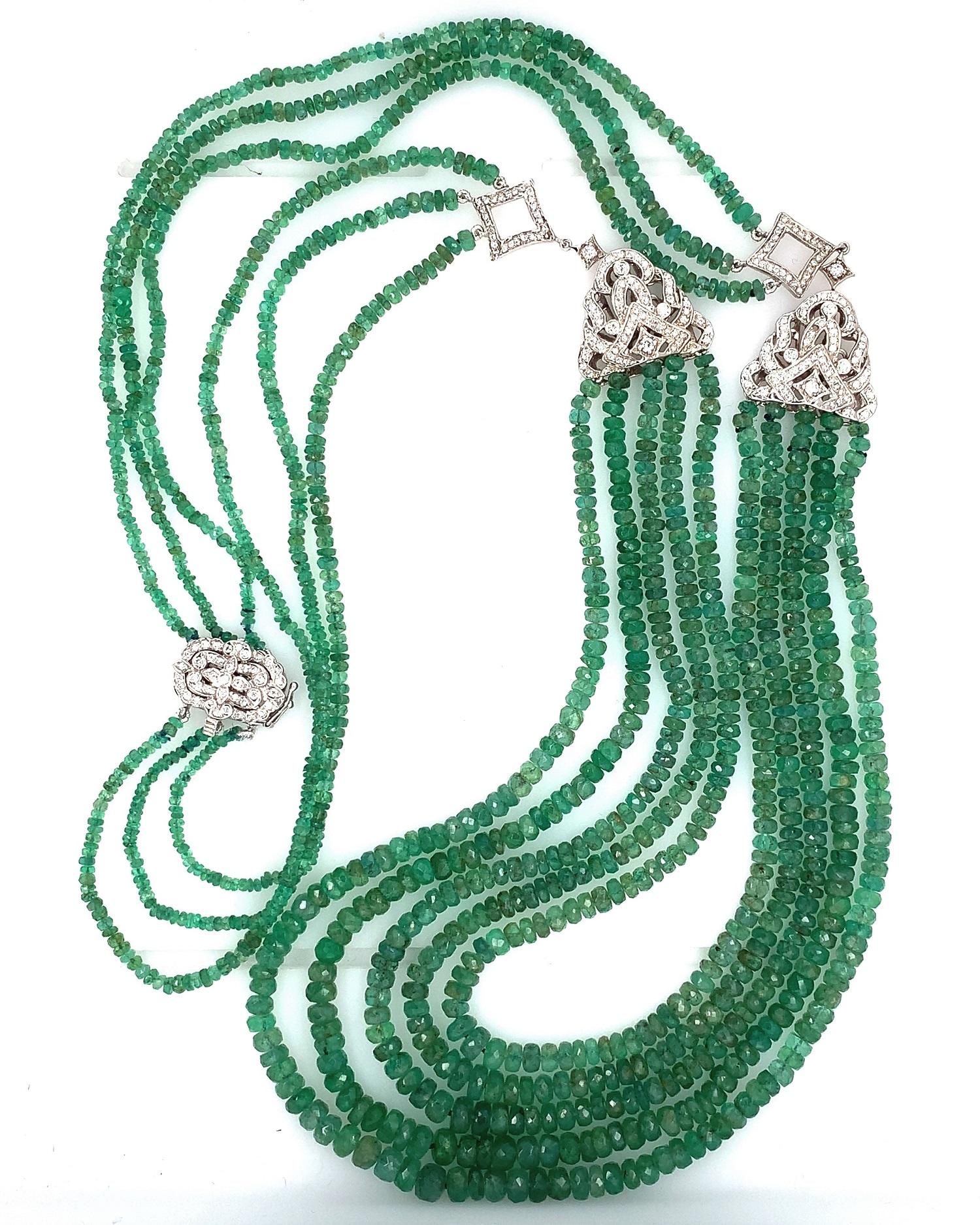 A multi-strand emerald necklace containing 300 carats of green faceted genuine emerald beads accented by 14K white gold and diamonds. It measures 29 1/2