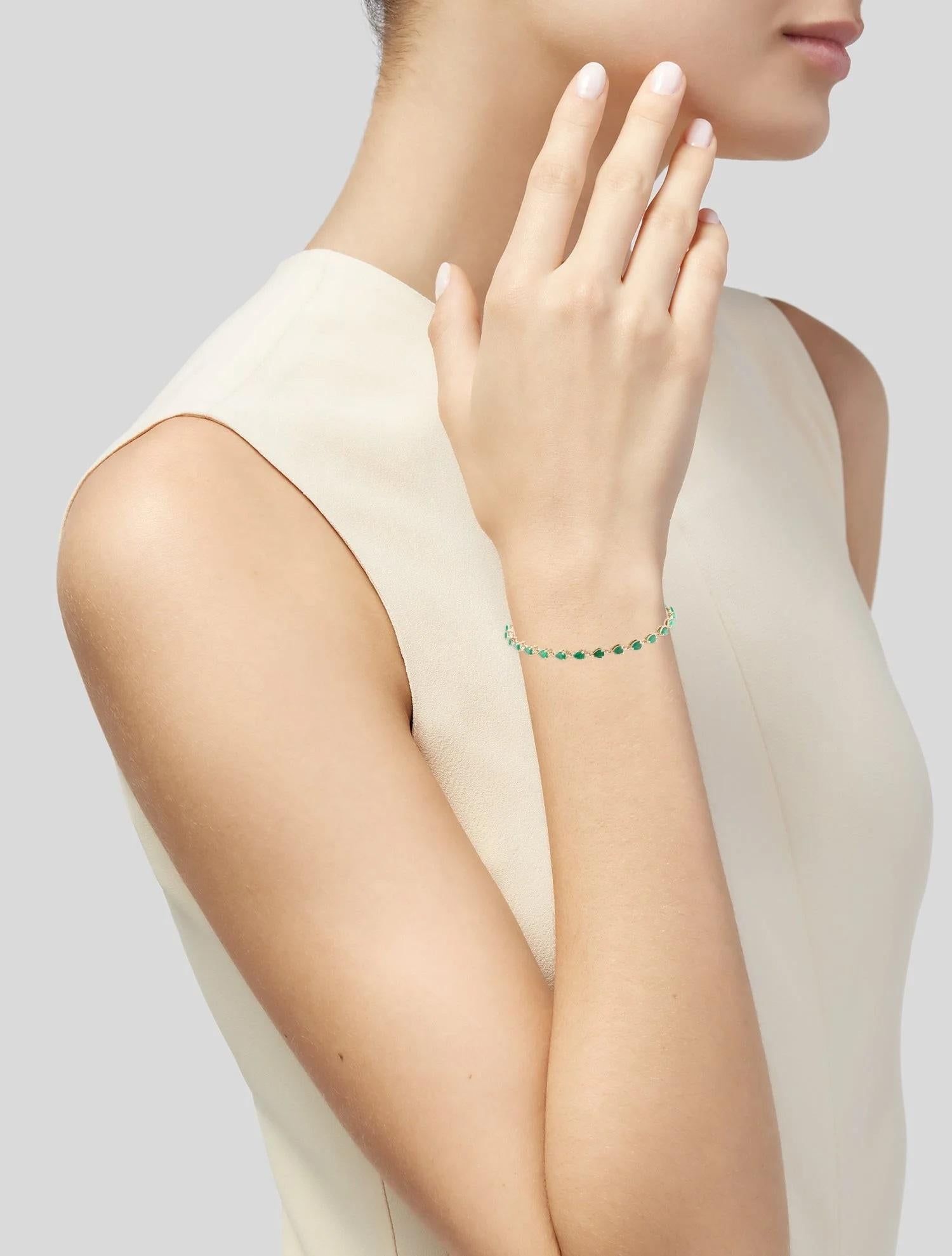 Illuminate your wrist with the captivating beauty of this 14K yellow gold tennis bracelet, featuring a stunning 3.80 carat faceted pear-shaped emerald. With 27 meticulously set emeralds displaying a rich green hue, this bracelet is a timeless