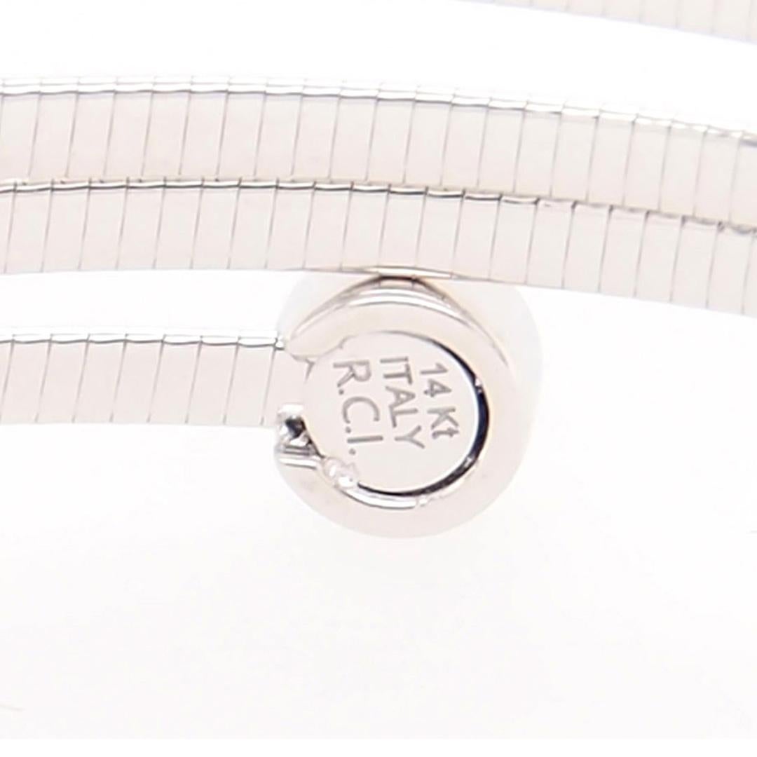 This is a great 14K White Gold 4 Band Wrap Bracelet with Diamond Bezel Ends.  Set with (14) Round Brilliant Cut Diamonds G-H in color, VS-SI in clarity and approximately 0.14 carat total weight.  A delightful Bangle that is flexible and wraps